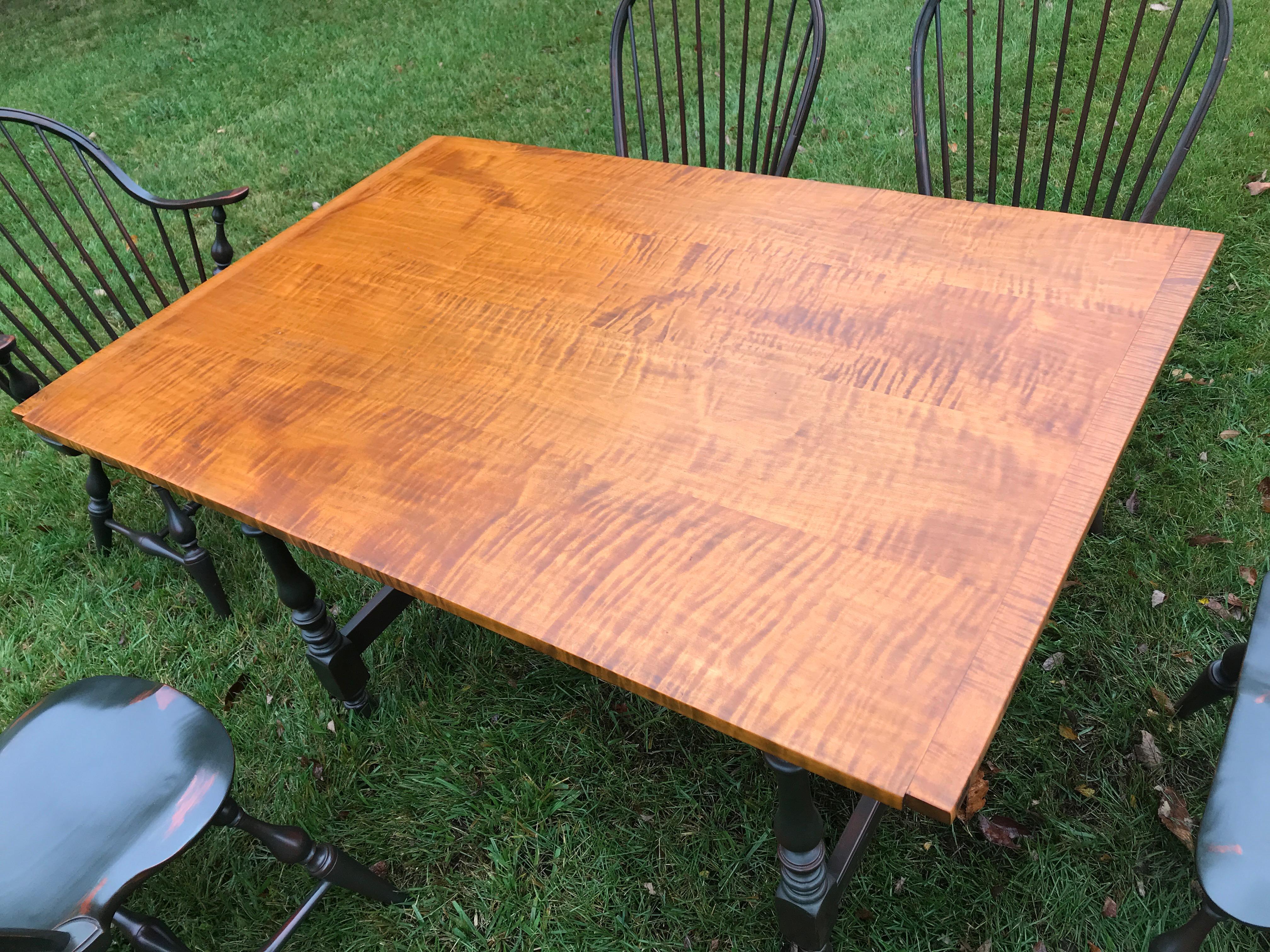 Reproduction tavern table in tiger maple and green distressed base, 6 matching windsor chairs, two 14