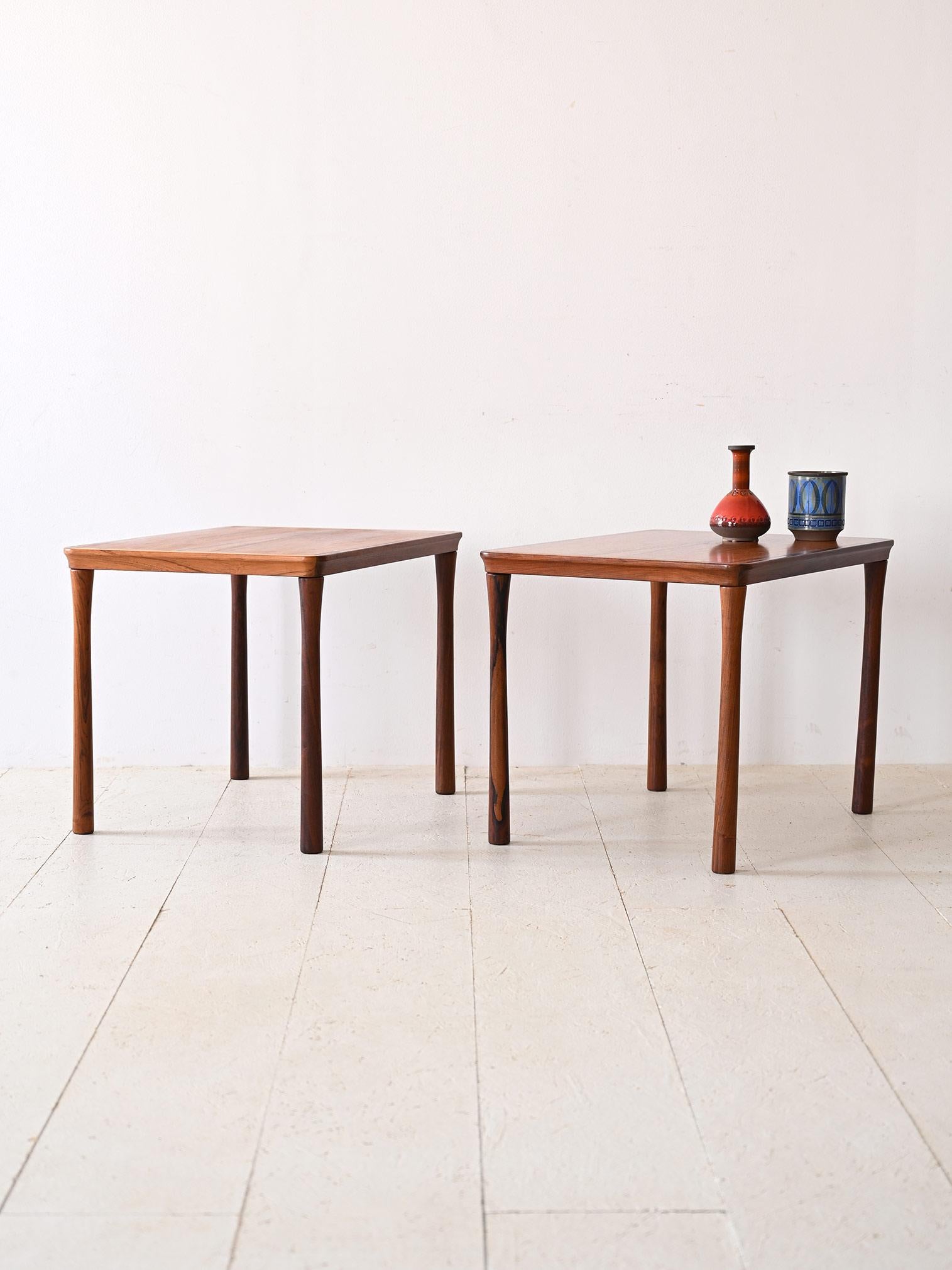 Pair of Danish coffee tables from the 1960s. 

The square top, with its beveled corners, lends a soft touch to the overall design, creating a visual harmony that blends seamlessly with the retro aesthetic. Rosewood, with its pronounced grain and