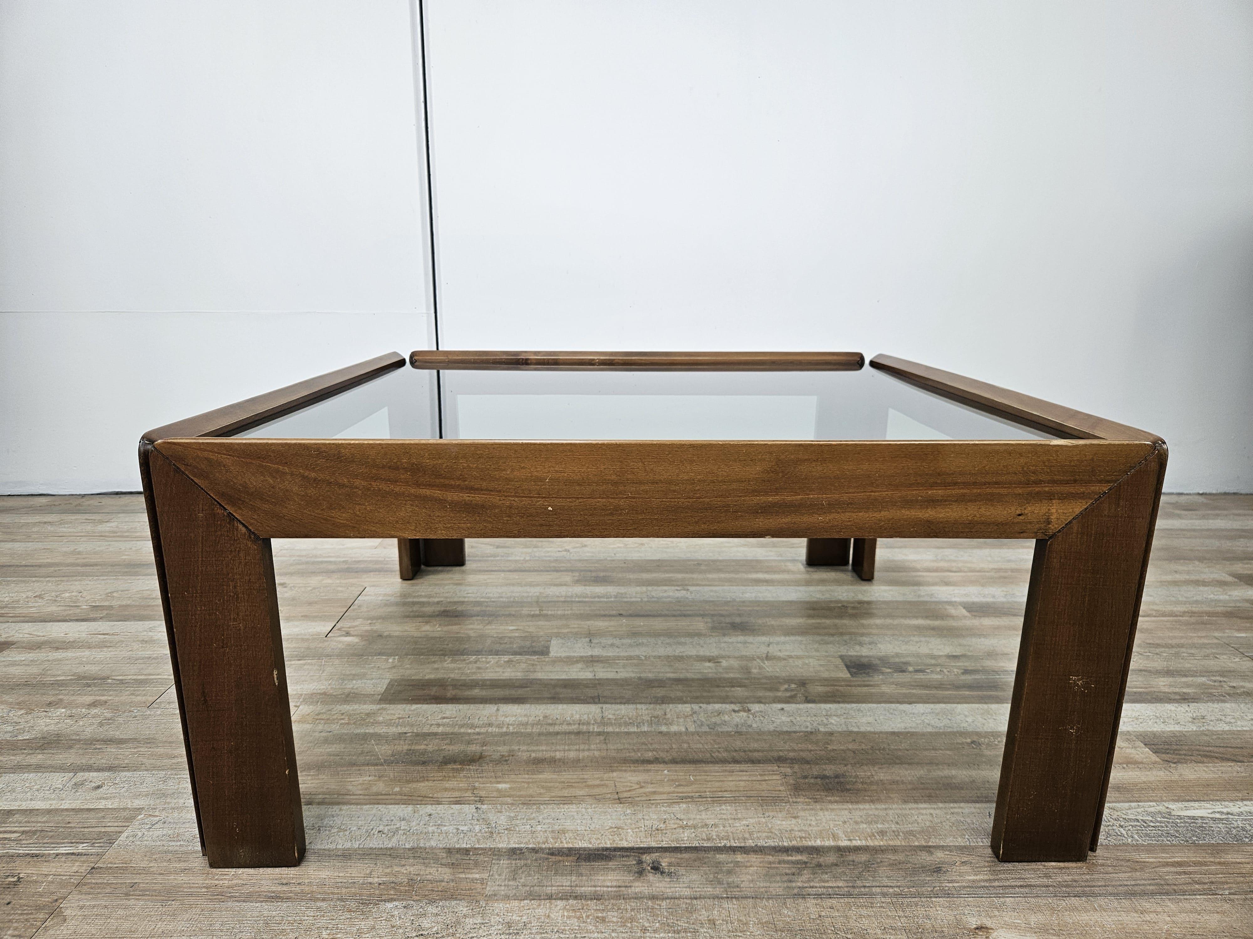 An icon of 1960s Italian design, this coffee table looks to enhance any type of room from modern to antique, thanks to its soft, elegant lines.

All-walnut frame with a distinctive smoked glass top that can be matched with any decor.

Designed by