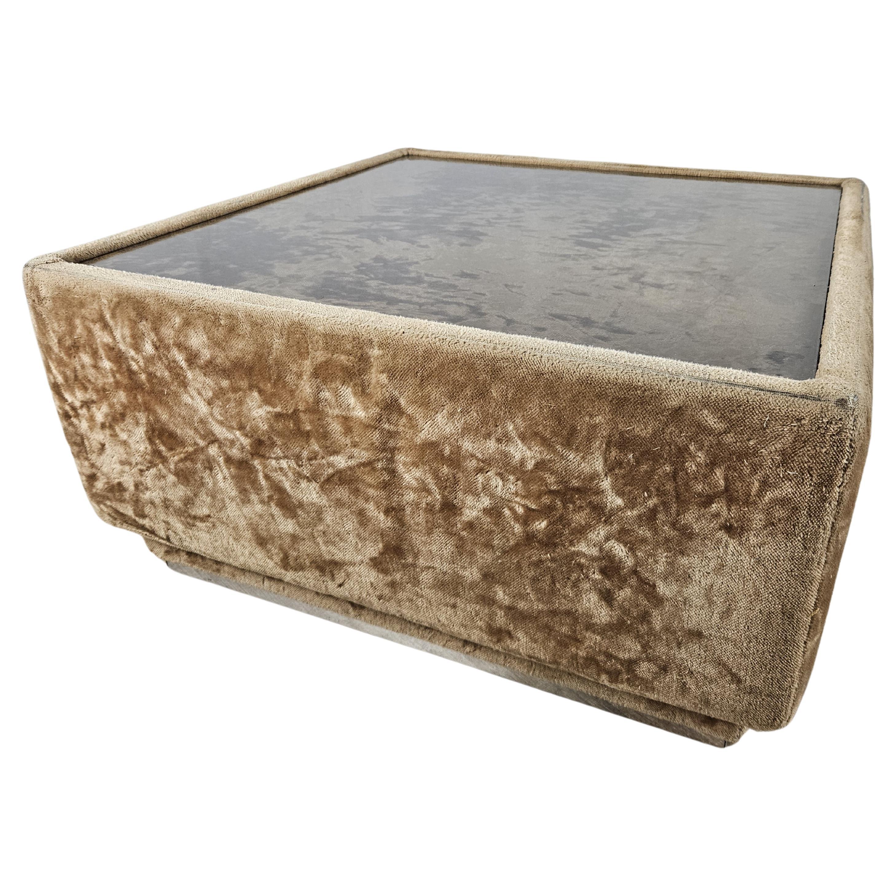 Fabric-covered 1970s coffee table with glass top