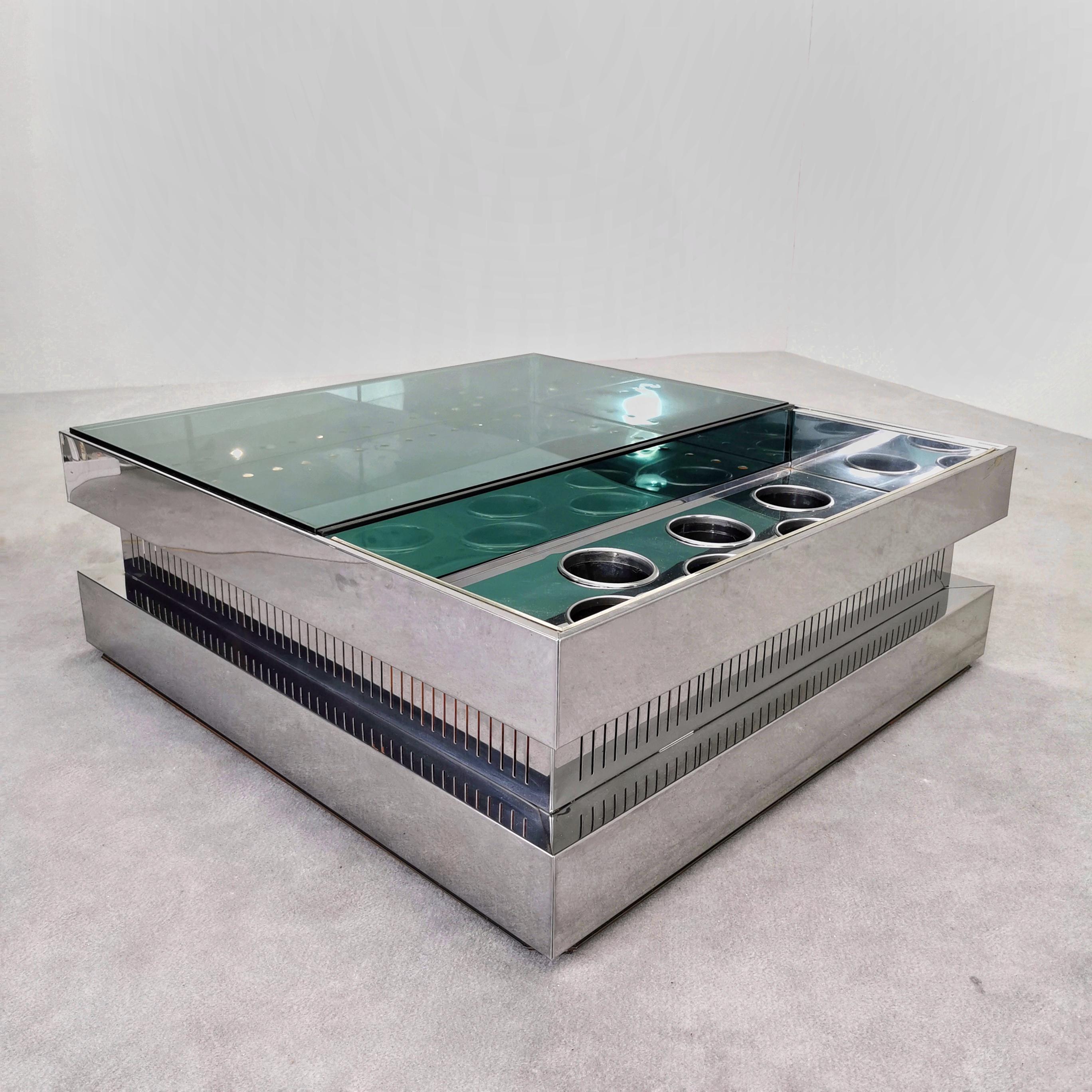 1970s Living Room bar table made of steel sheet and glass. 
Rare space age piece consists of glass top and bottle holder accommodations with pull-out elements. 
The coffee table lights up, creating a special atmosphere at parties or relaxing