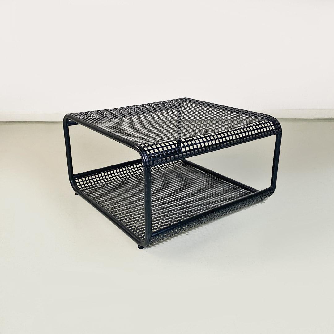 Low table with matte black metal frame with square base and rounded corners, with tubular profiles and second lower shelf, also made of perforated metal.
1980 ca.
Good overall condition, top folded in the middle part.
Measurements in cm