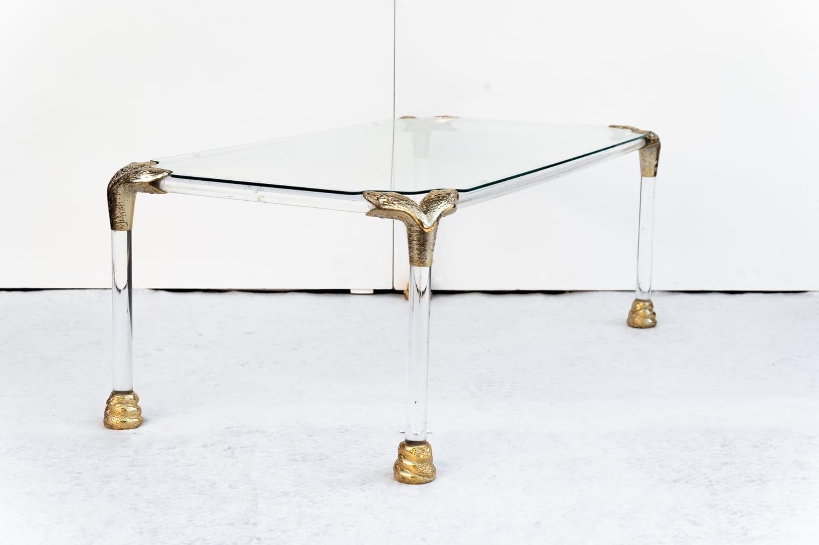 Table basse en verre acrylique et laiton, fabriquée en Italie, années 1970.  
Le cadre et les pieds sont en verre acrylique avec un plateau en verre. Cette table basse est très élégante grâce à ses détails uniques, tels que les coins en laiton en