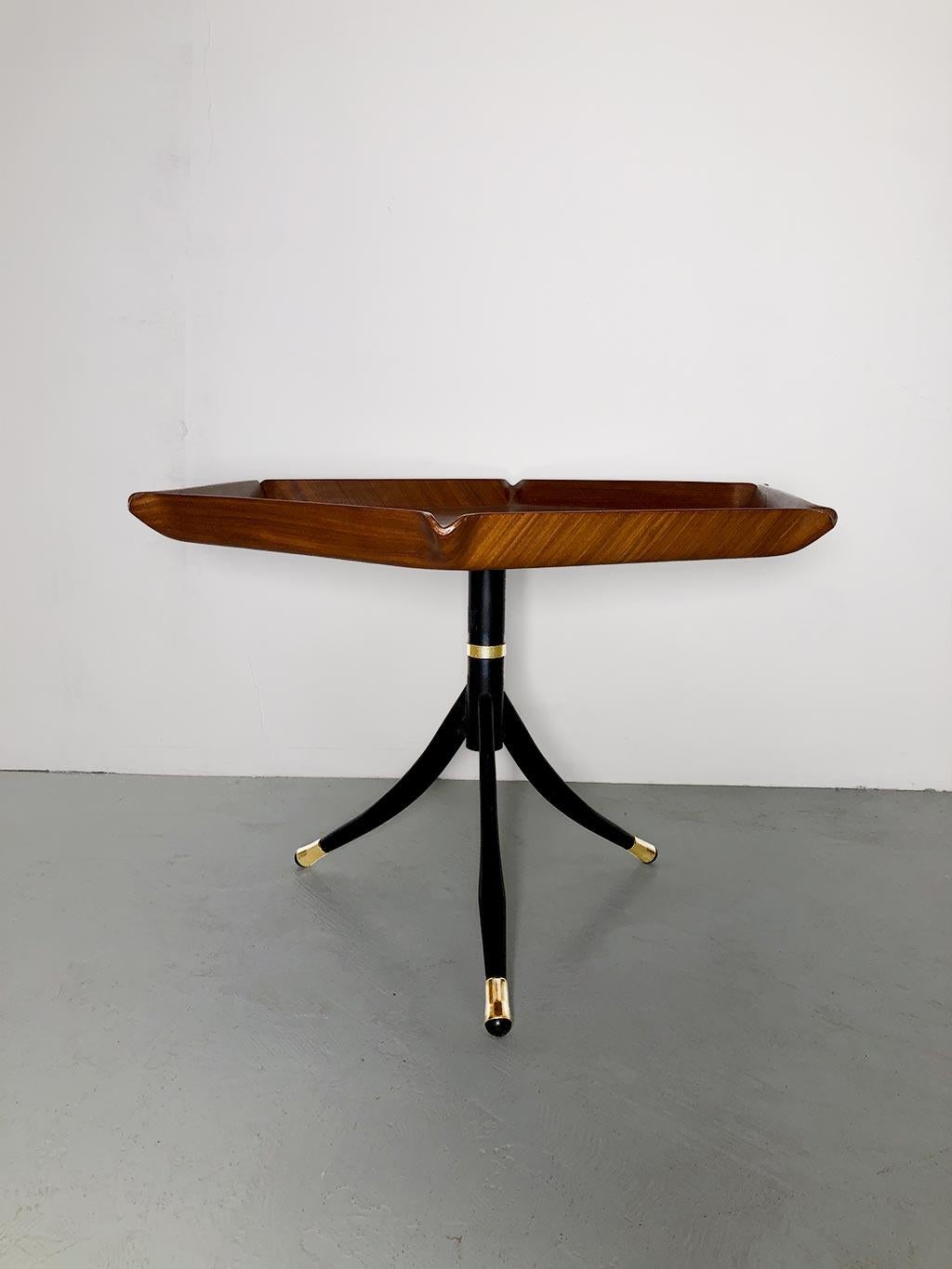Italian coffee table, produced in the style of Franco Campo and Carlo Graffi (both part of and collaborators with the Turin school of Carlo Mollino). Hexagonal top made of curved and molded teak wood, black lacquered metal frame with gold inserts.