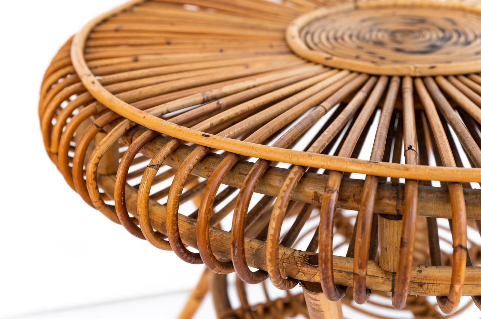 Wicker and bamboo round coffee table, Made in Italy, 1970s. 
Beautiful round coffee table made of bamboo and curved rattan. This coffee table has two tops with sturdy frame. The lower and upper floors are made of curved rattan with woven wicker. It