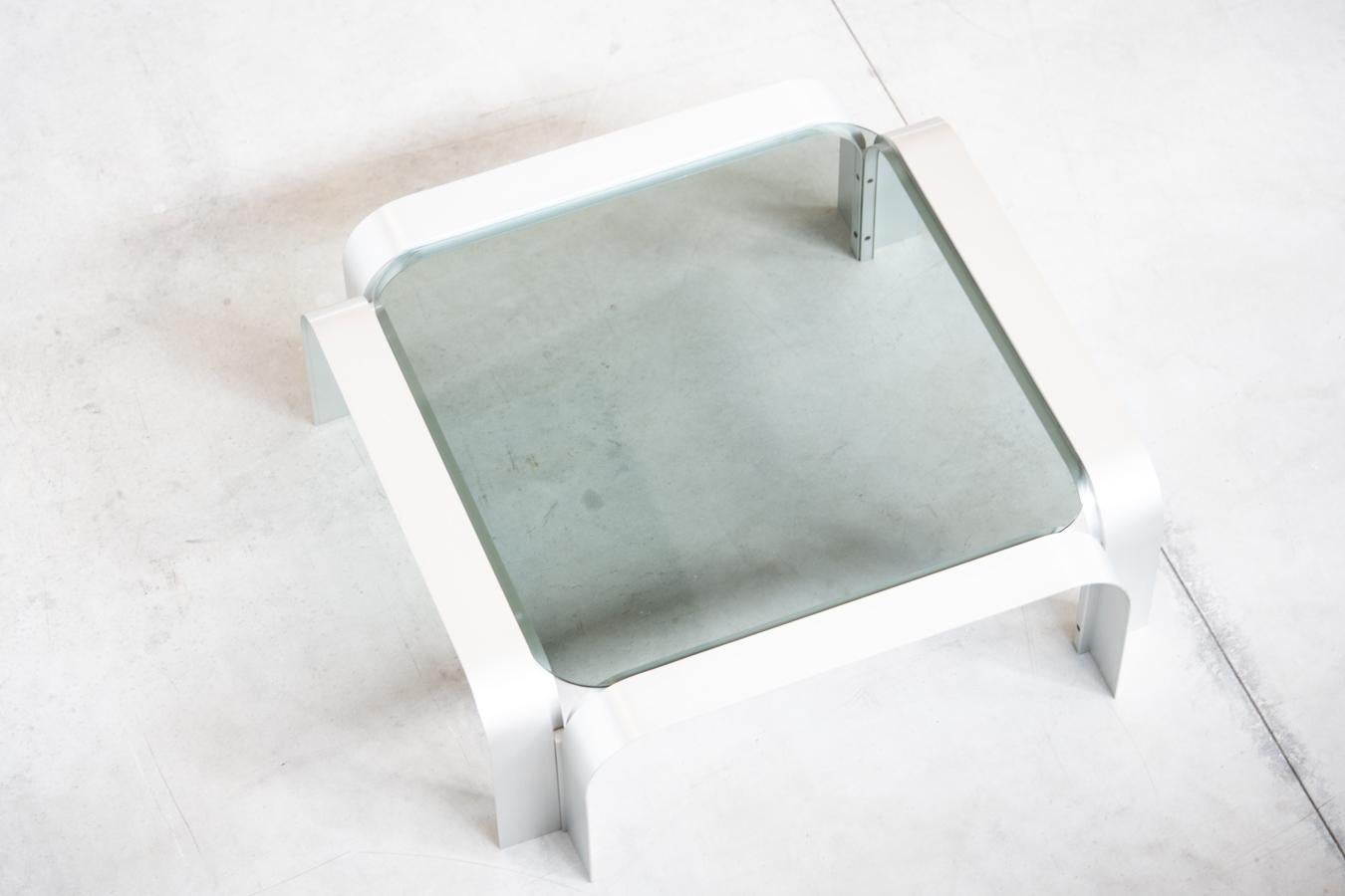 Sculptural coffee table, 1960s/'70s
Flat, space-age coffee table with high quality brutalist design 	produced in Germany. It presents a large sculptural stucture, consisting of 4 	bent aluminum profiles. Brushed aluminum gives a finish 	opaque. This