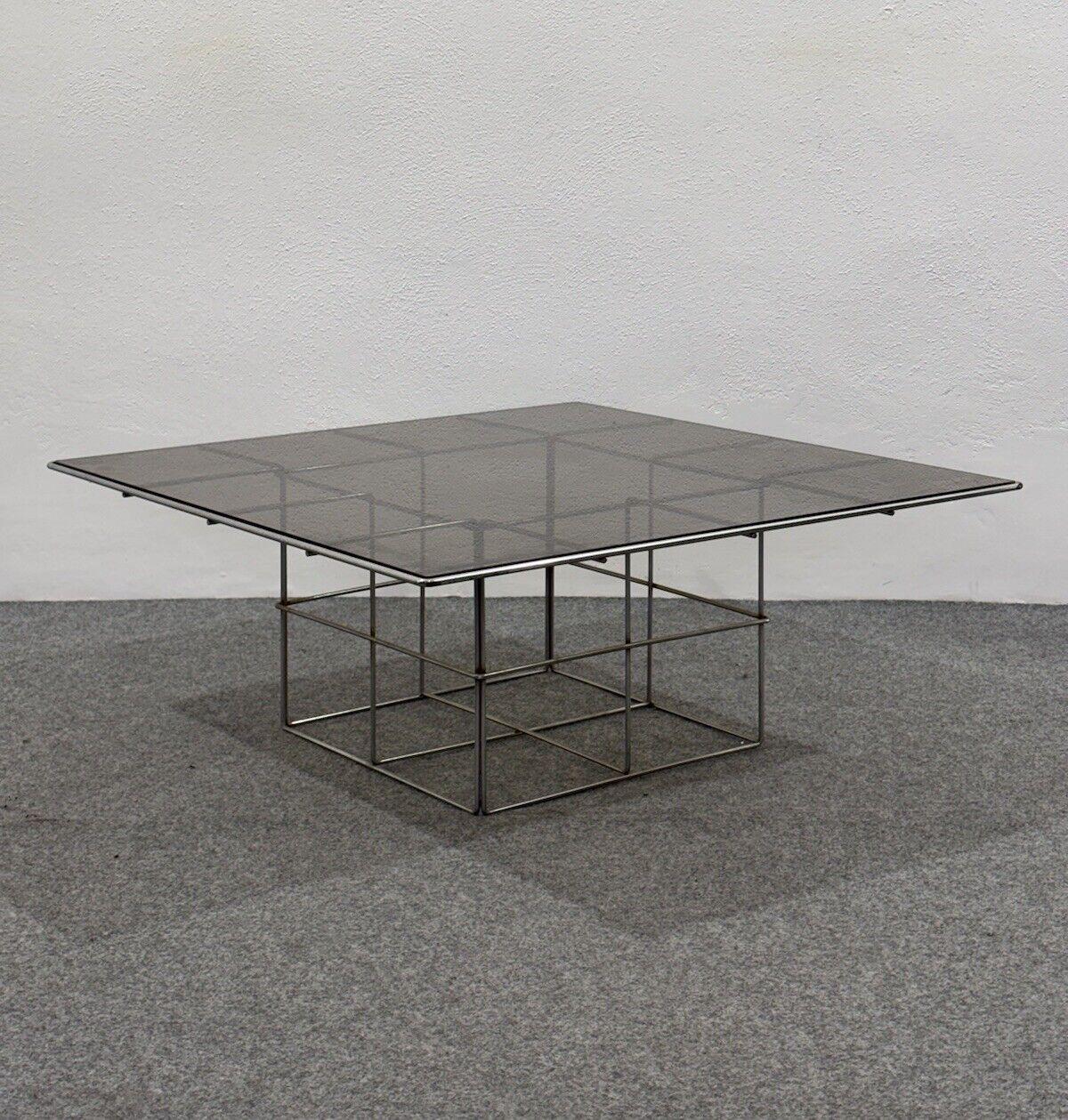 Wonderful coffee table made of chrome-plated steel and sepia-colored glass top, made in the 1970s, Italian manufacture.

The item is in good conservative condition, no major cosmetic or structural defects to report, just slight and obvious signs of