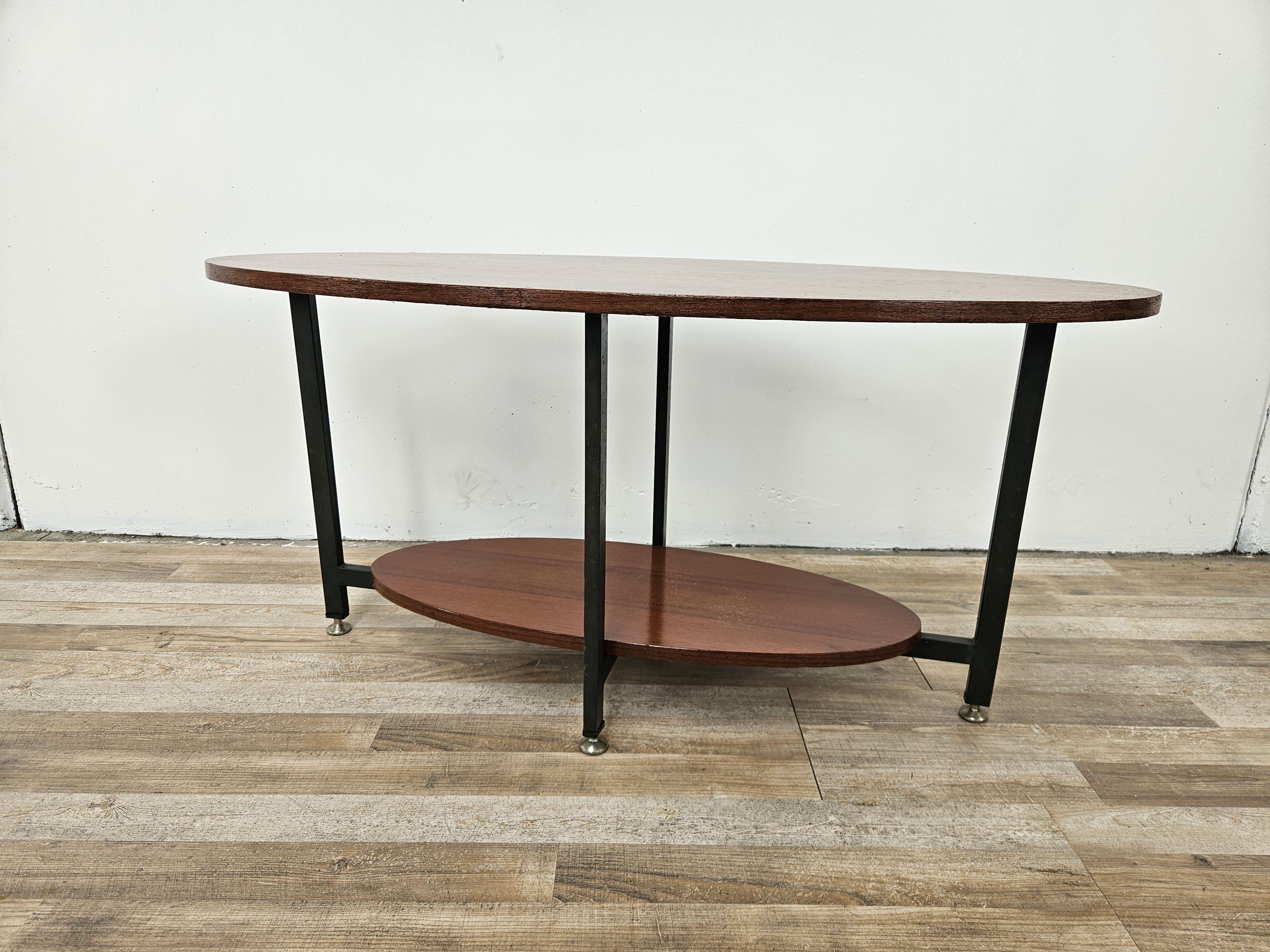 Scandinavian 1960s oval teak wood coffee table with iron frame and adjustable feet.

First shelf height 11.5cm 

Shellac polished, shows normal marks from age and use.