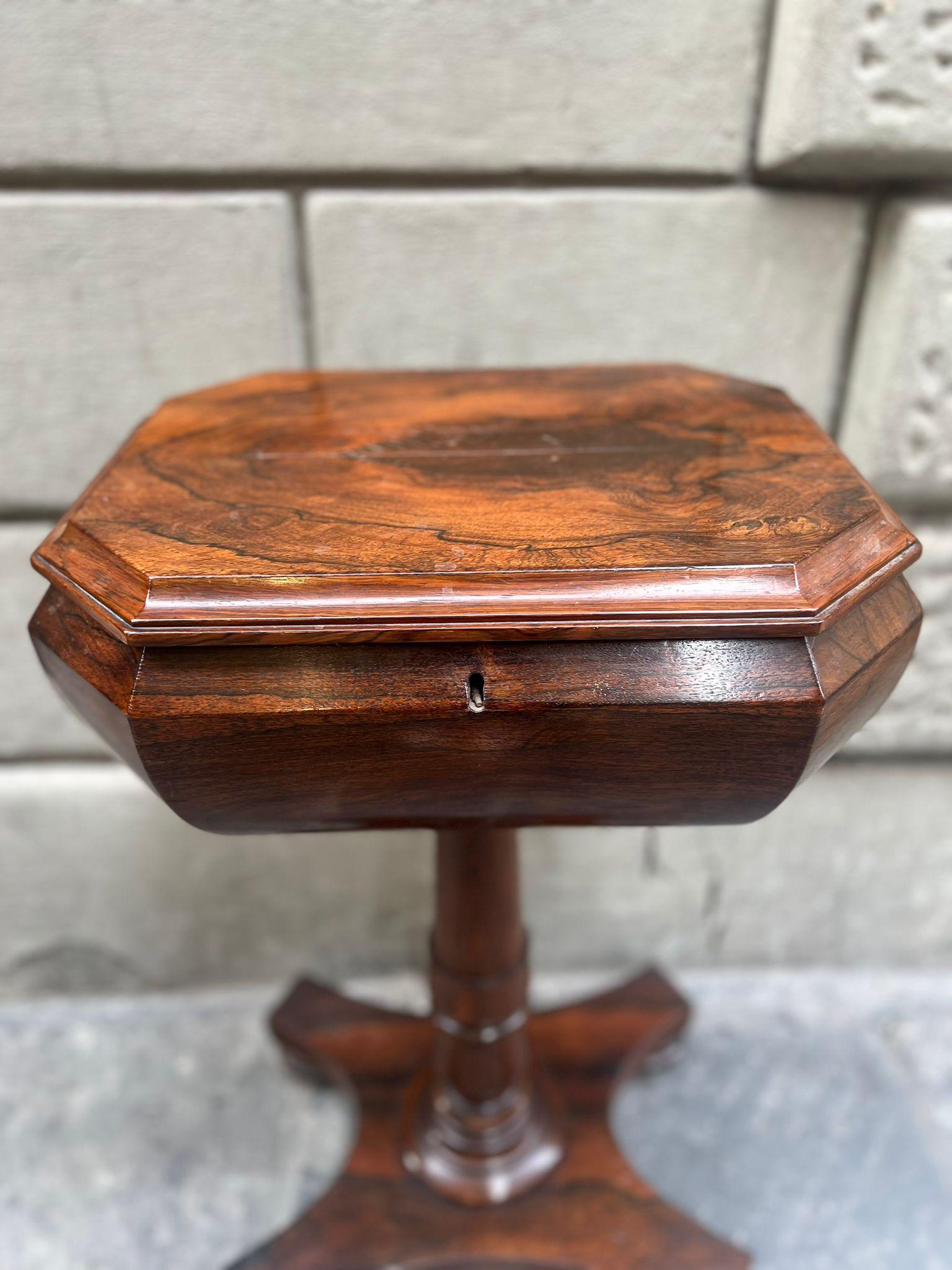 Rosewood tea table, mid-19th century.

Inside, the coffee table has specially designed compartments to hold two teacups and the necessities for making the drink.