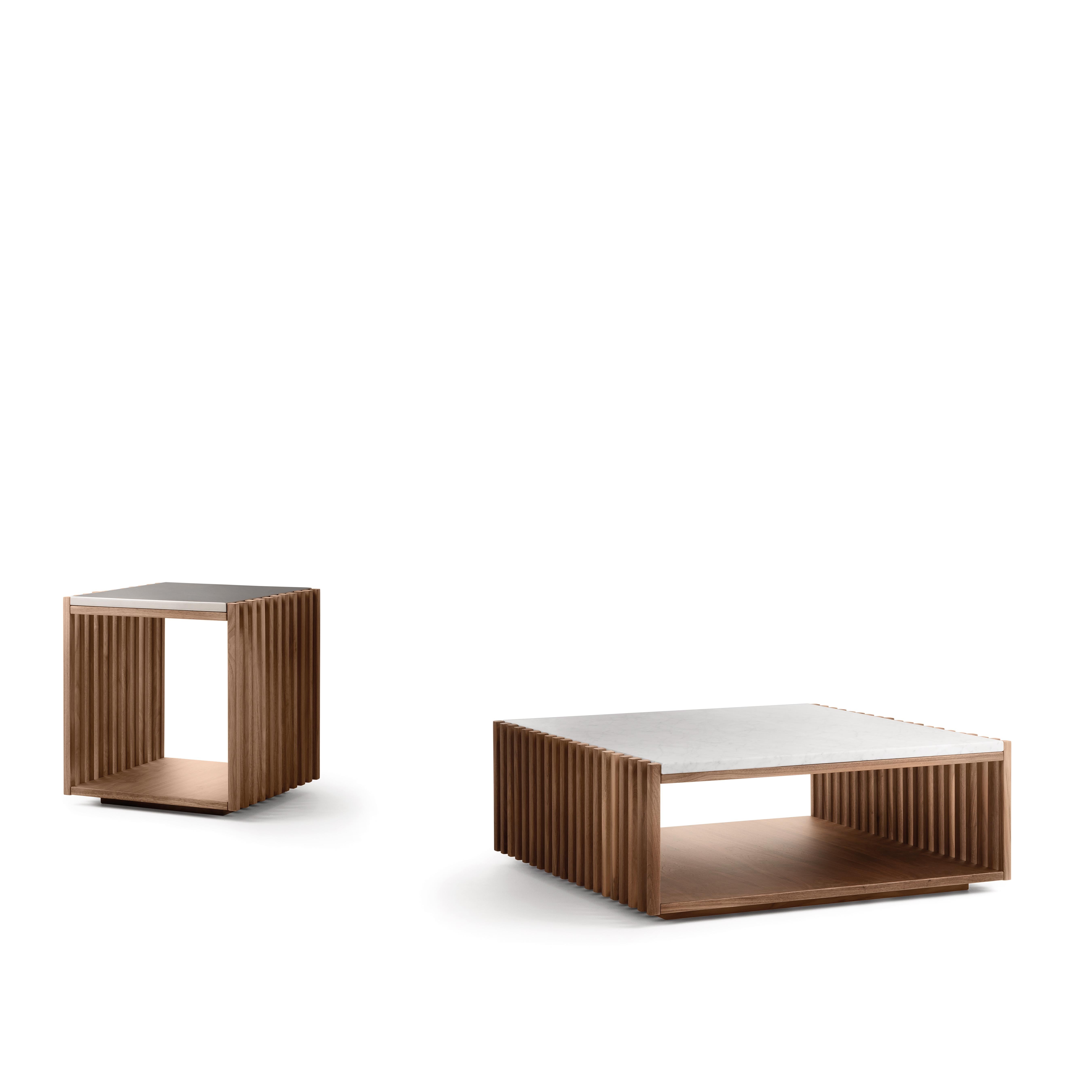 The Bolgheri coffee table, shaped like a wide, low parallelepiped, was designed by 74 RAM.
Pair of Bólgheri small tables featuring basic shapes and pure volumes. 
The design is inspired by the light playing between the strips and casting different