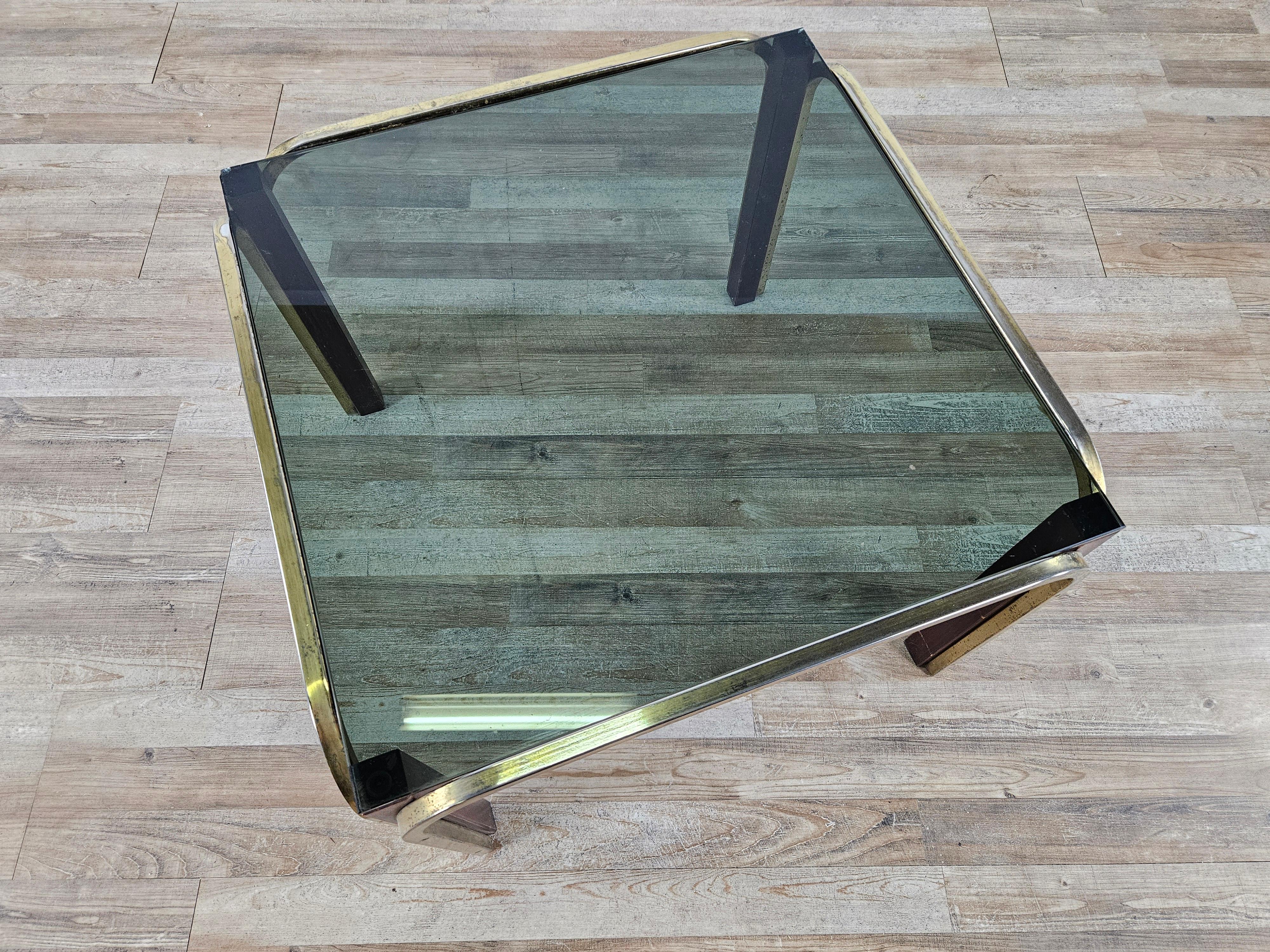Gold metal coffee table with wooden legs and smoked glass top.

Glass has some cracks in two corners, recommended new glass or cloth top.