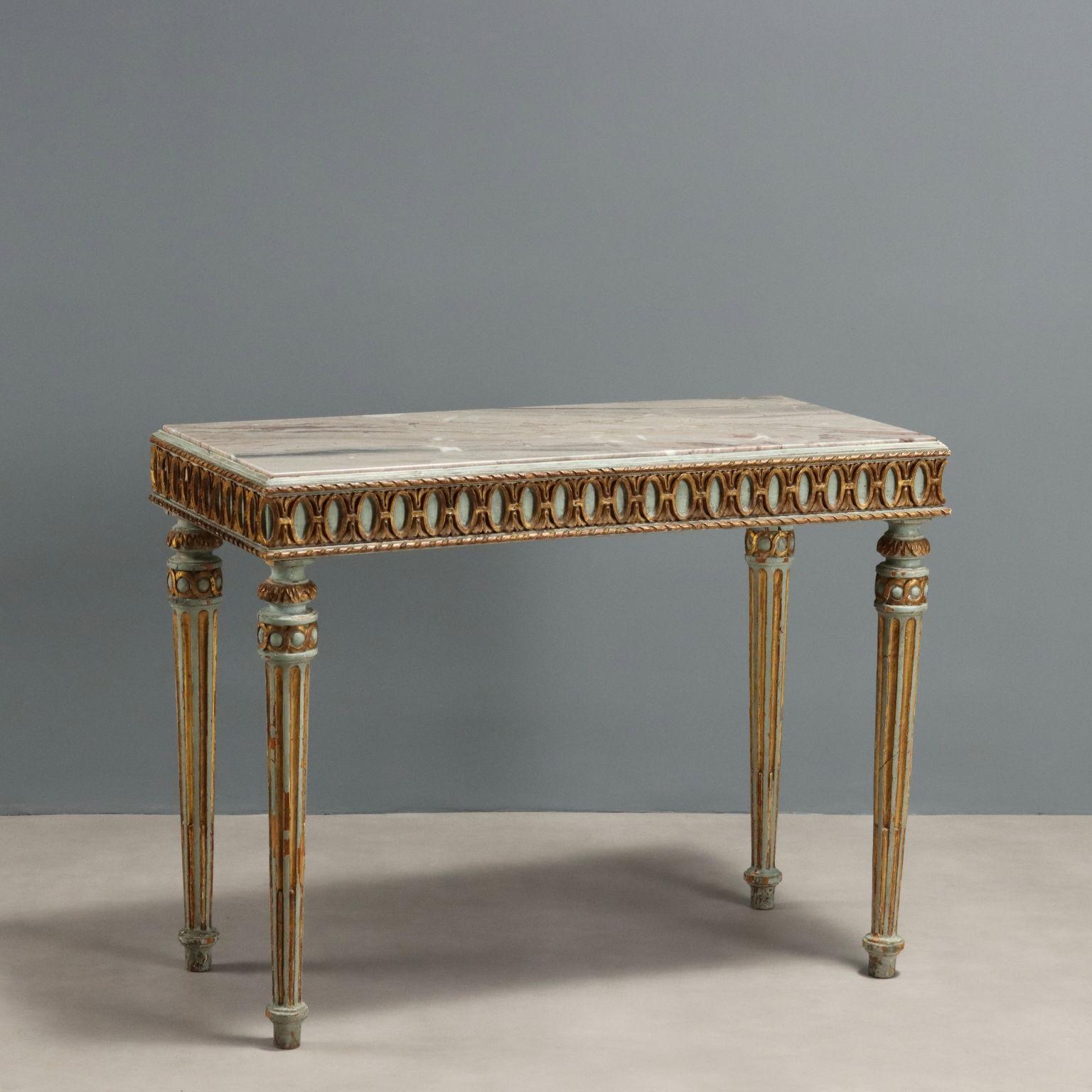 Lacquered and gilded wooden coffee table, rectangular top resting on four tapered truncated legs. Neoclassical gilt carvings in the under-top band and legs. Marble top replaced.
Italy, early 20th century.	
