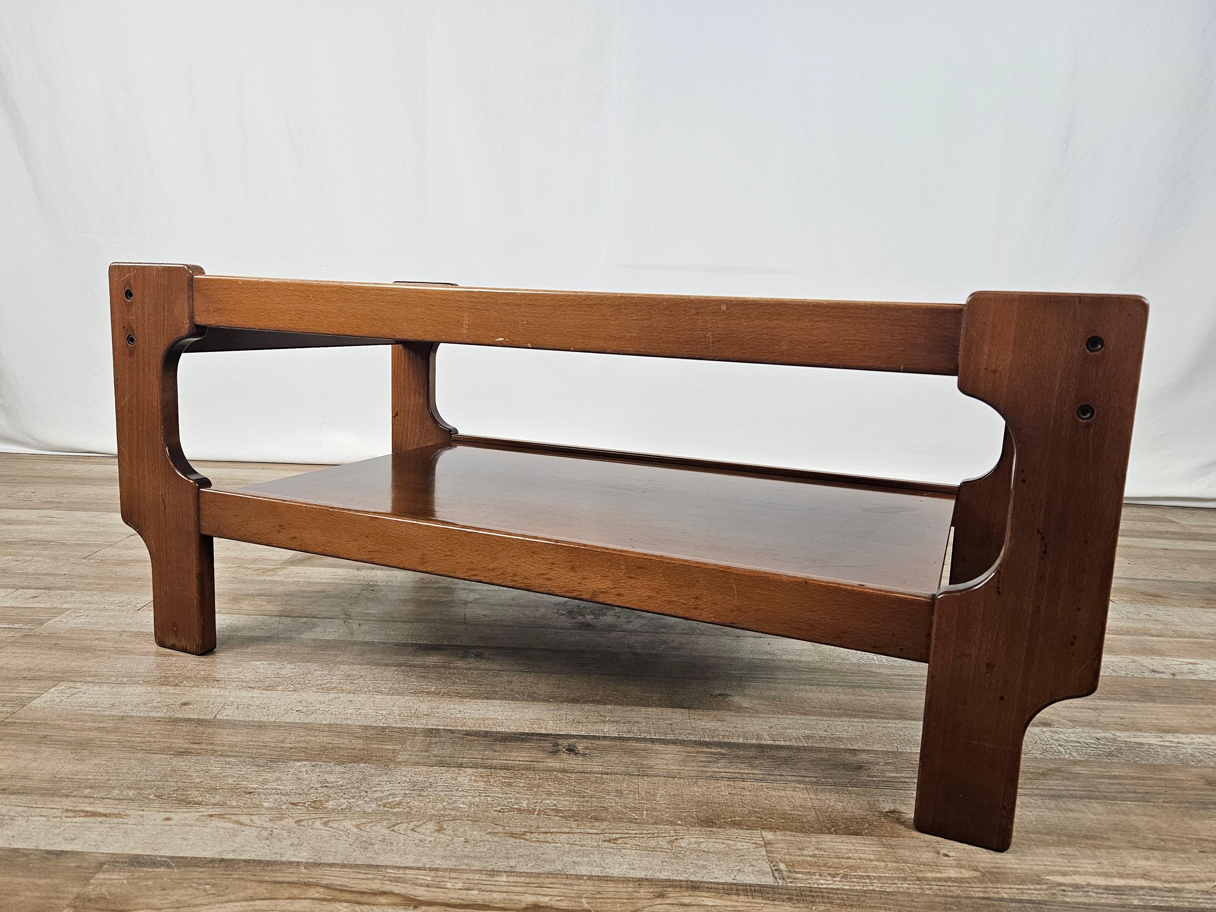Teak wood coffee table with double shelf, one main shelf in smoked glass and one in wood.

Great furniture idea of 1970s Italian design and modernism.