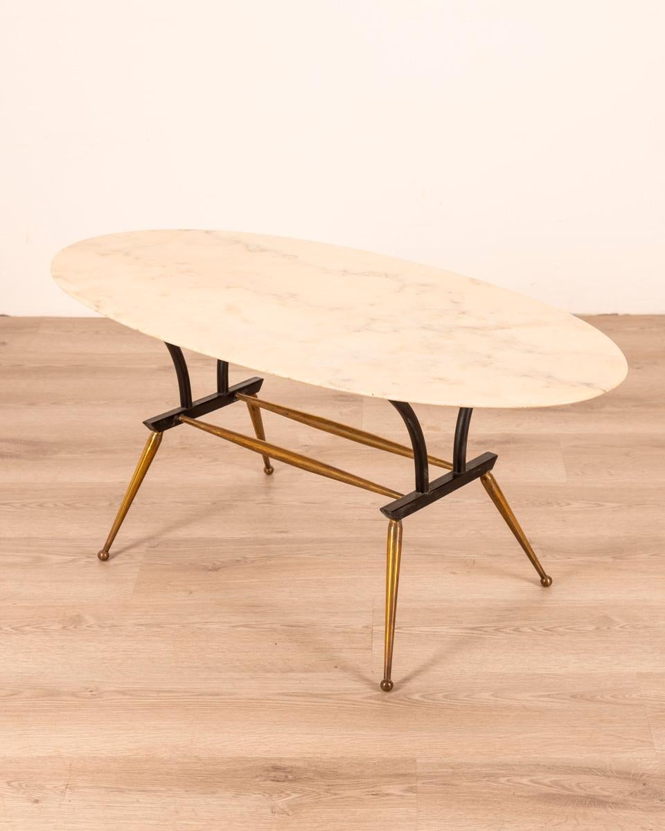 Coffee table with gilt brass and black metal frame, white marble top, Italian design, 1960s.

CONDITION: In good condition, may show signs of wear given by time.

DIMENSIONS: Height 70 cm; width 165 cm; length 85 cm;

MATERIAL: Brass metal and