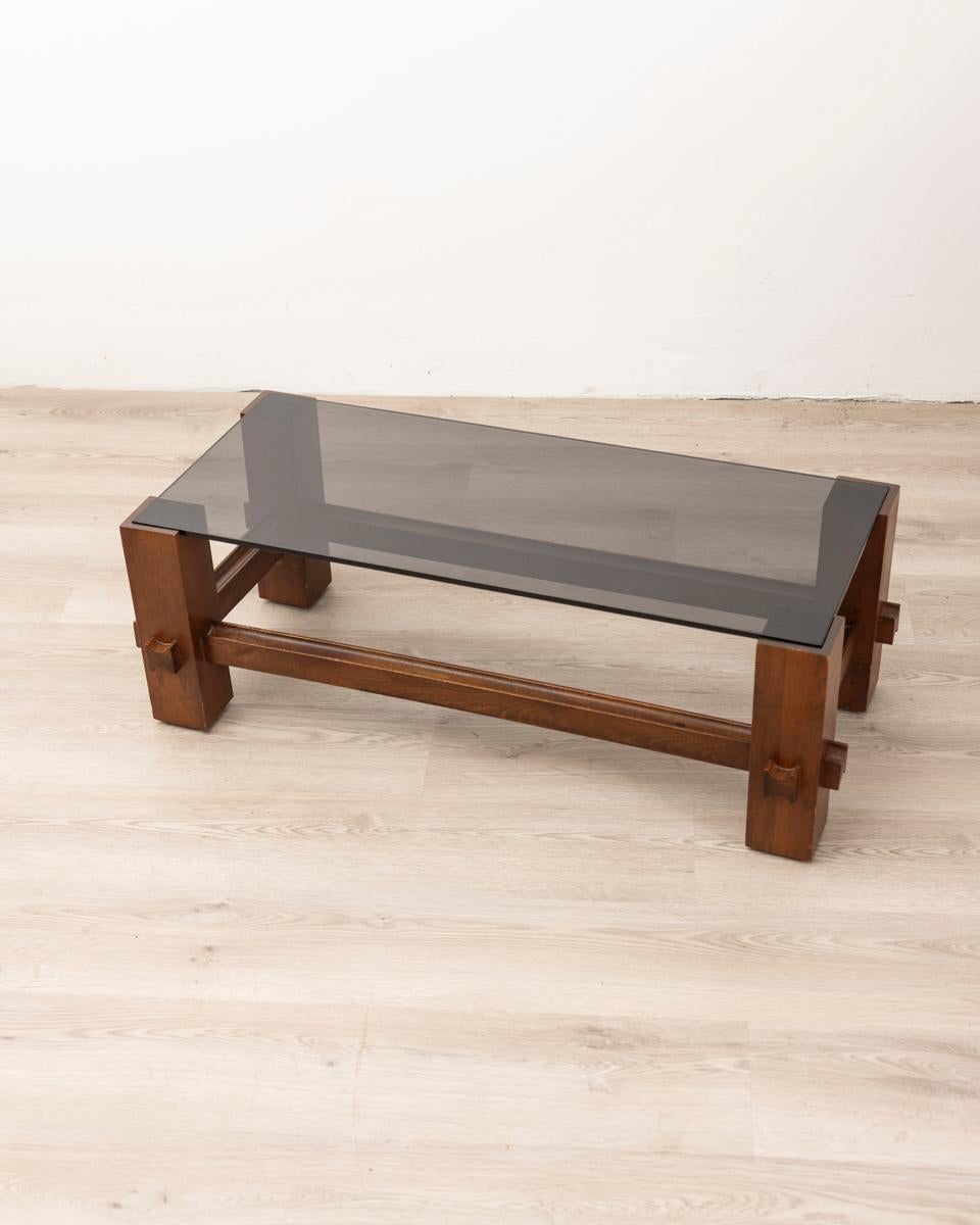 Coffee table in polished Walnut wood and smoked glass top, design Fontana Arte, 1960s.

CONDITION: In good condition, may show signs of wear given by time.

DIMENSIONS: Height 32.5 cm; Width 94 cm; Length 32.5 cm

MATERIALS: Wood and Glass

YEAR OF