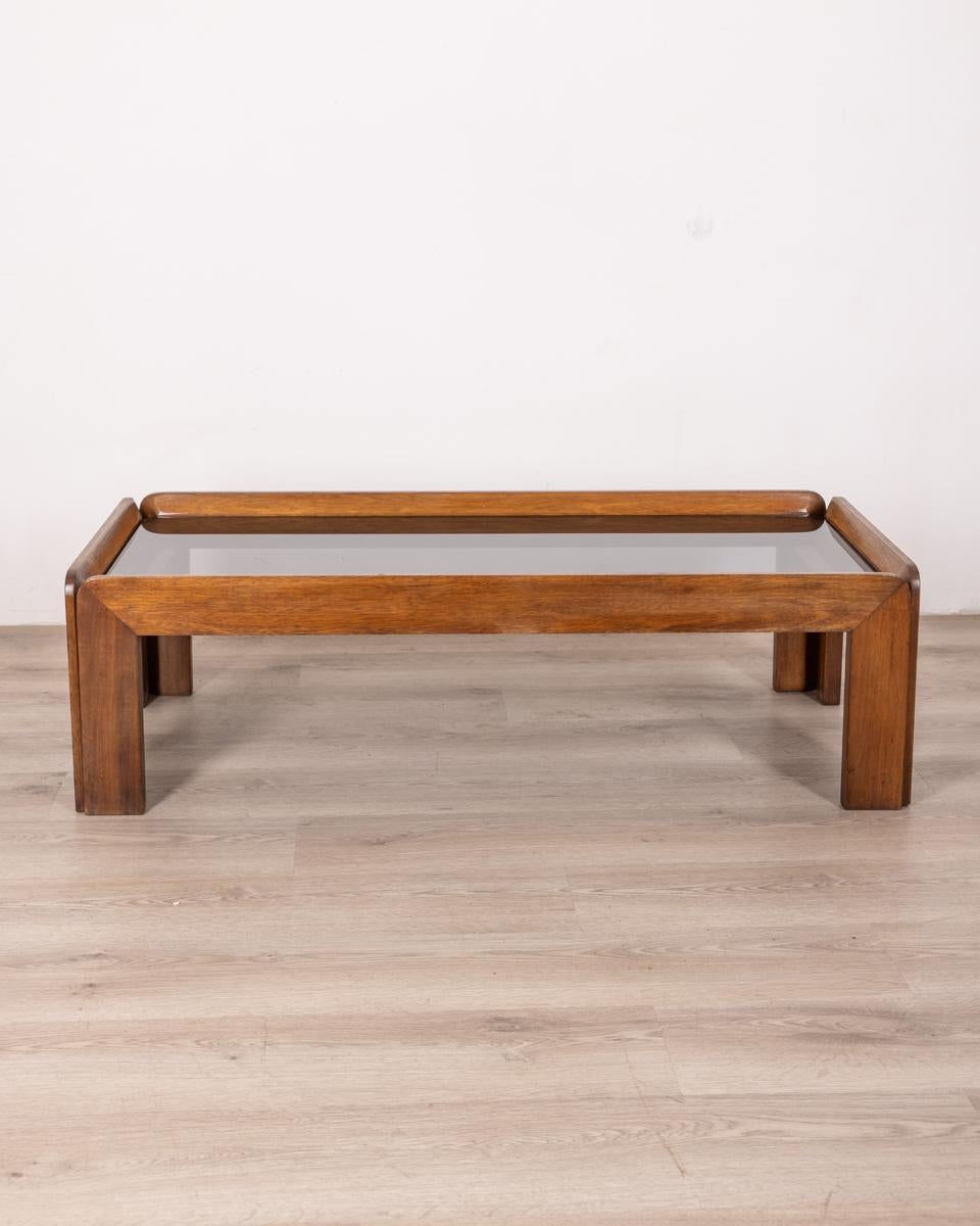 Coffee table in polished Walnut wood and smoked glass top, design Afra & Tobia Scarpa, 1970s.

CONDITION: In good condition, may show signs of wear given by time.

DIMENSIONS: Height 35 cm; Width 120 cm; Length 58 cm

MATERIALS: Wood and Glass

YEAR