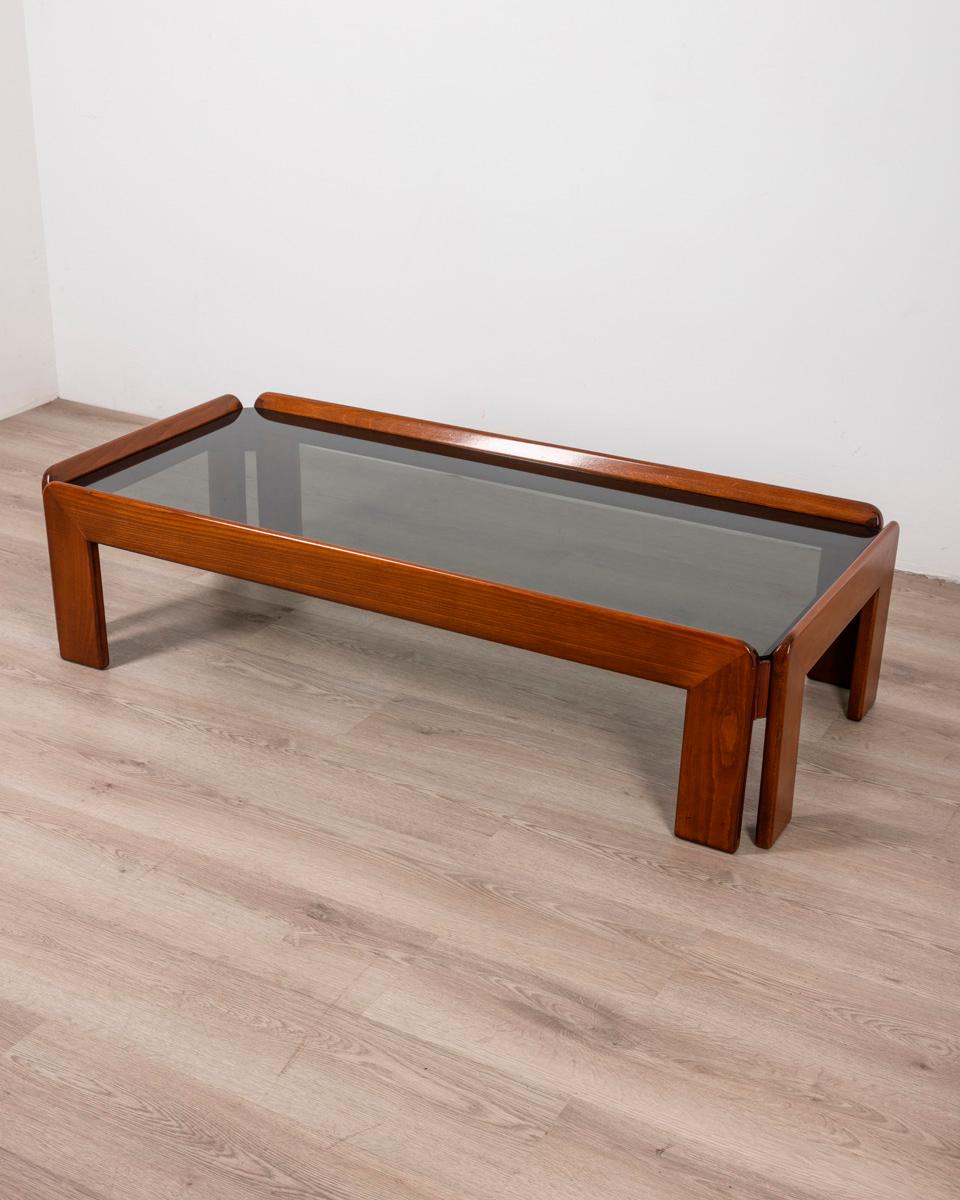 Coffee table in polished Walnut wood and smoked glass top, design Afra & Tobia Scarpa, 1970s.

CONDITION: In good, working condition, may show signs of wear given by time.

DIMENSIONS: Height 35 cm; Width 134 cm; Length 63 cm

MATERIALS: Wood and