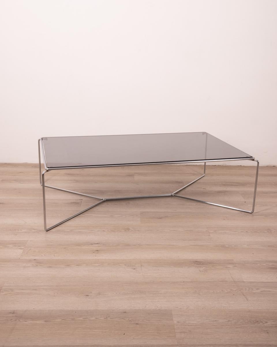Coffee table with chrome-plated metal frame and smoked glass top.
Marcel 470 model, design Kazuhide Takahama for Simon Cassina, 1970s.

CONDITION: In good condition, may show signs of wear given by time, glass has a chipping visible in