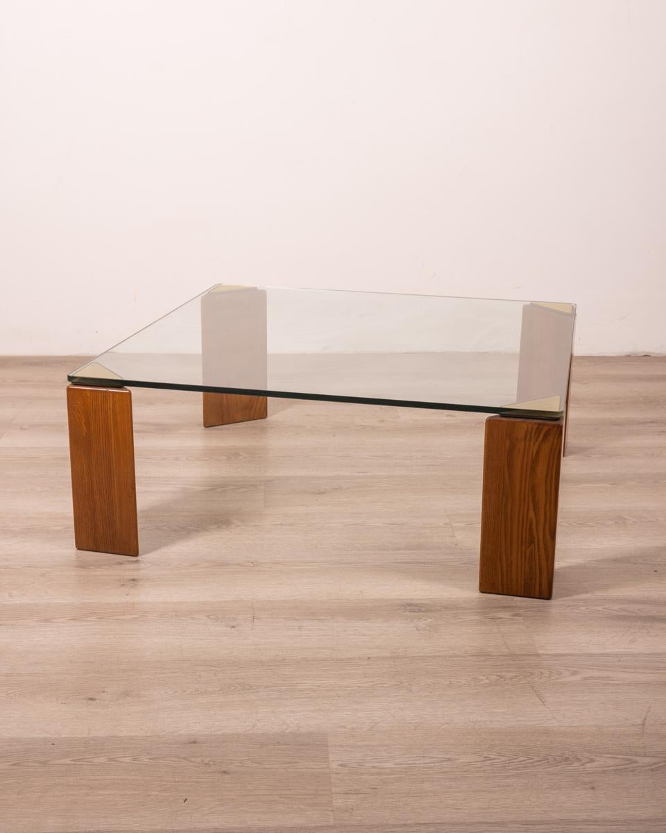 Wood frame coffee table with gilt brass inserts, clear glass top, 1980s, Italian design.

CONDITION: In good condition, may show signs of wear given by time.

DIMENSIONS: Height 33 cm; Width 85 cm; Length 85 cm

MATERIALS: Wood, Brass and