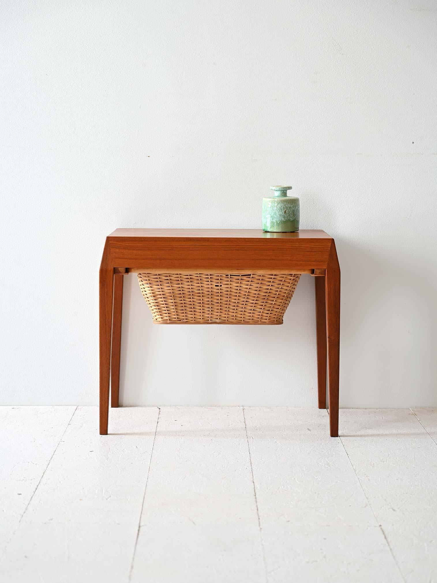 Scandinavian modernist coffee table designed by Severin Hansen with woven rattan compartment.

Featuring a teak frame with a minimalist design. Under the top is a woven rattan compartment, originally designed to hold sewing materials. The modern
