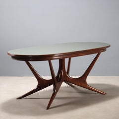 Italian Manifattura Italiana 1950s oval table in stained beech and glass top.