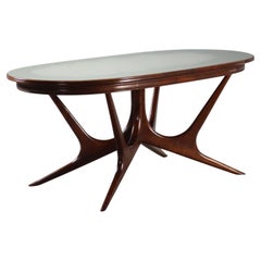 Italian Manifattura Italiana 1950s oval table in stained beech and glass top.
