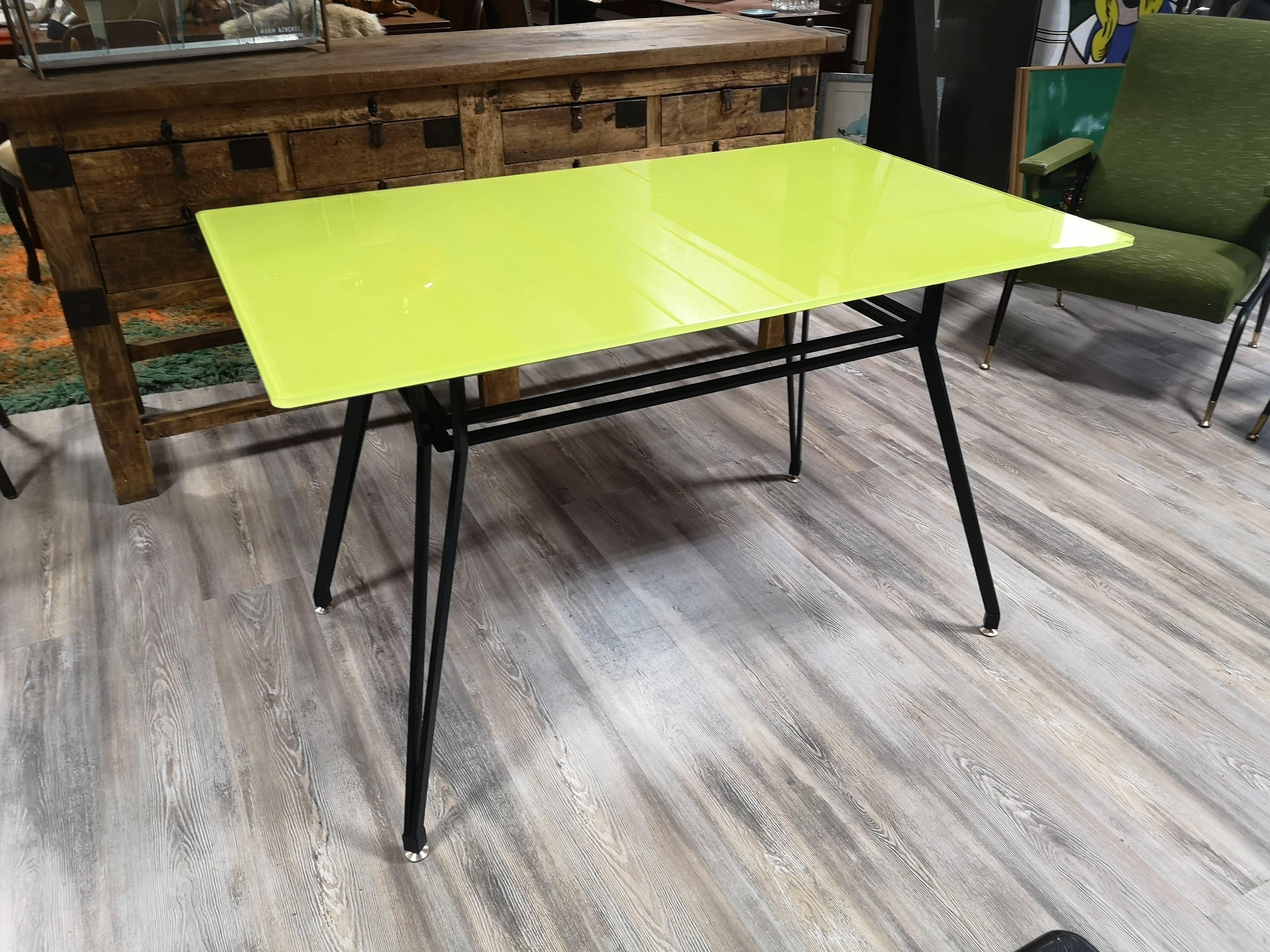 1950s dining table with iron frame and yellow/green glass top.
Adjustable brass feet.
Small size 125 x 75 cm. so it can also be placed in smaller living areas.
The stained glass top makes it perfect for young and lively environments.
It is also