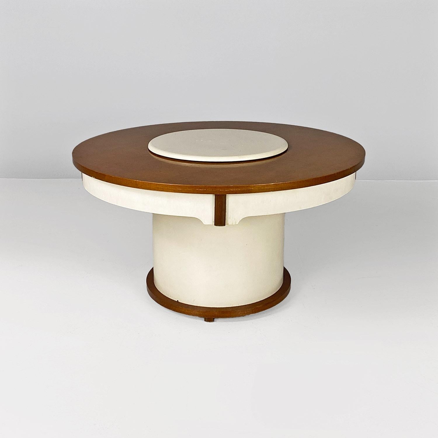 Coffee table, also known as Gervasino table, with wooden frame in natural color, with parts painted white. The white disk placed in the center of the top hides a bar storage compartment, which comes up automatically by moving a metal lever, located