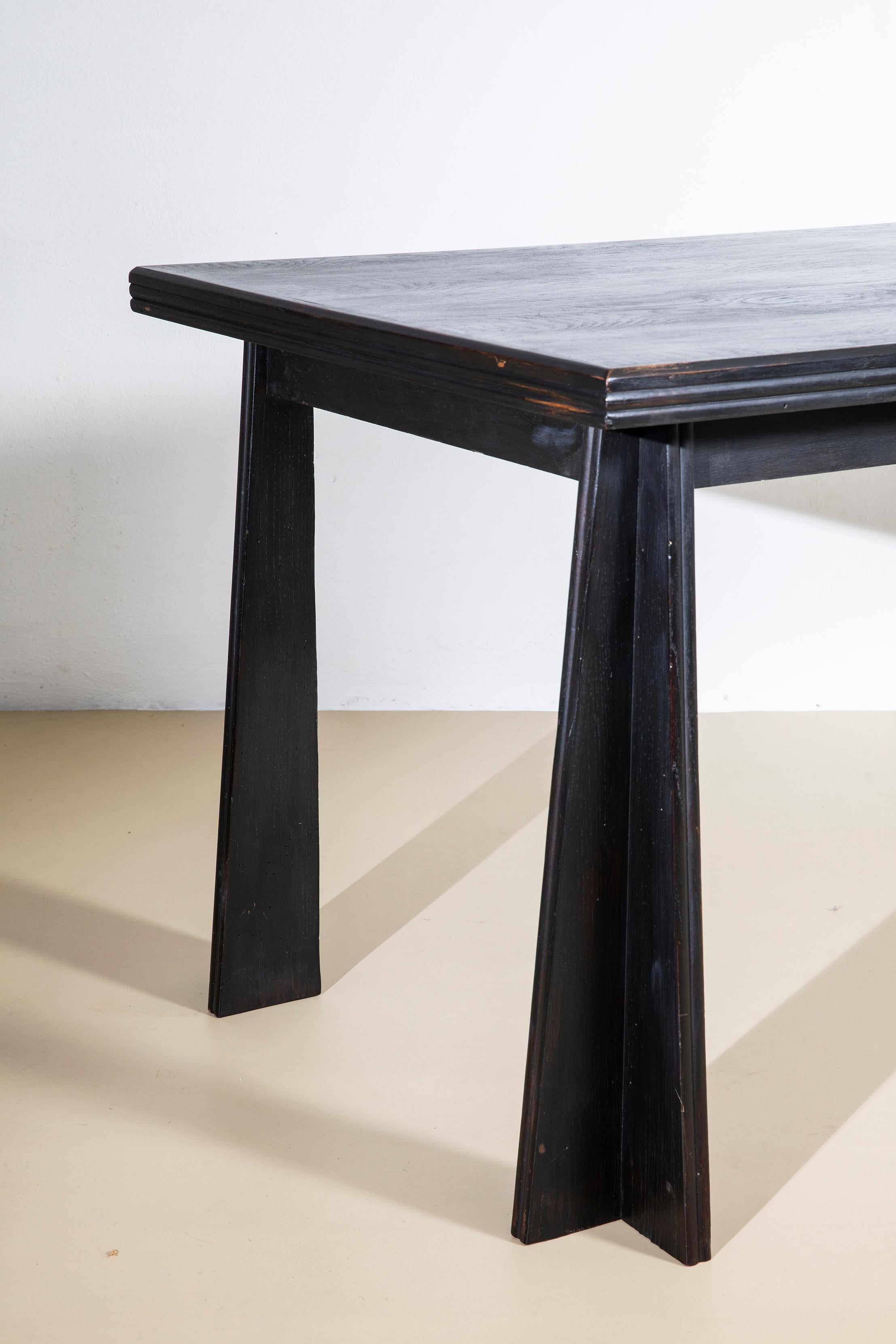 Ebonized oak dining table, early 1940s, recalls in design and form the style of Paolo Buffa. 