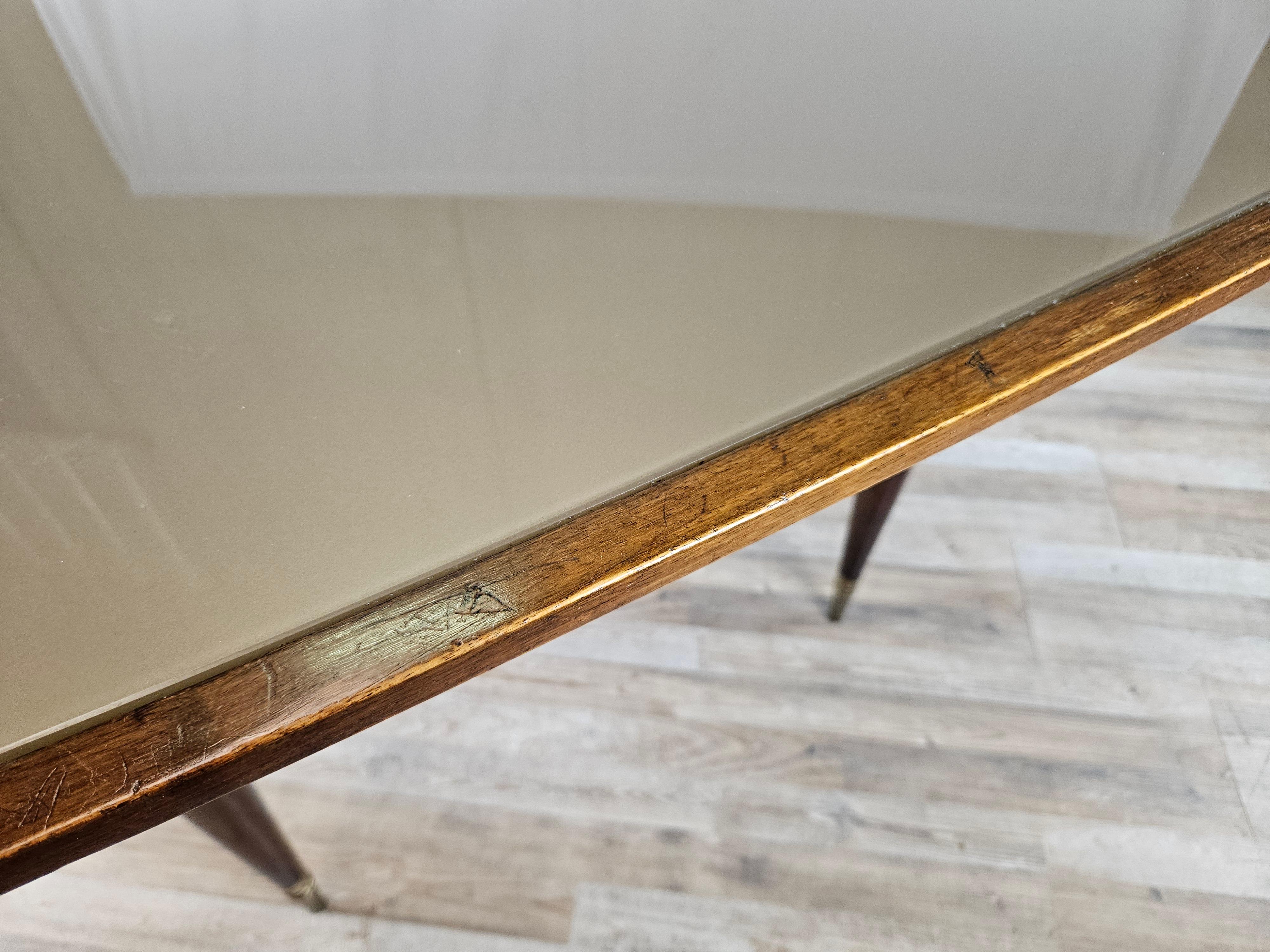 Italian Rectangular walnut dining table with glass top and brass decorations For Sale