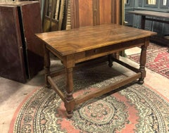 Rectangular walnut table with large central drawer, italy