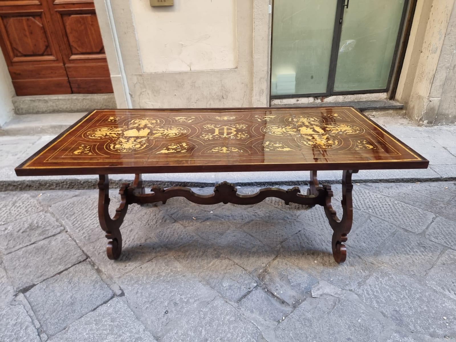 Extraordinary lyre-legged walnut table inlaid on the top with grotesque scenes. Grotesques are precisely a particular topi di decora that has its roots in Roman painting and was also rediscovered in the Renaissance period.

In the Florence capital