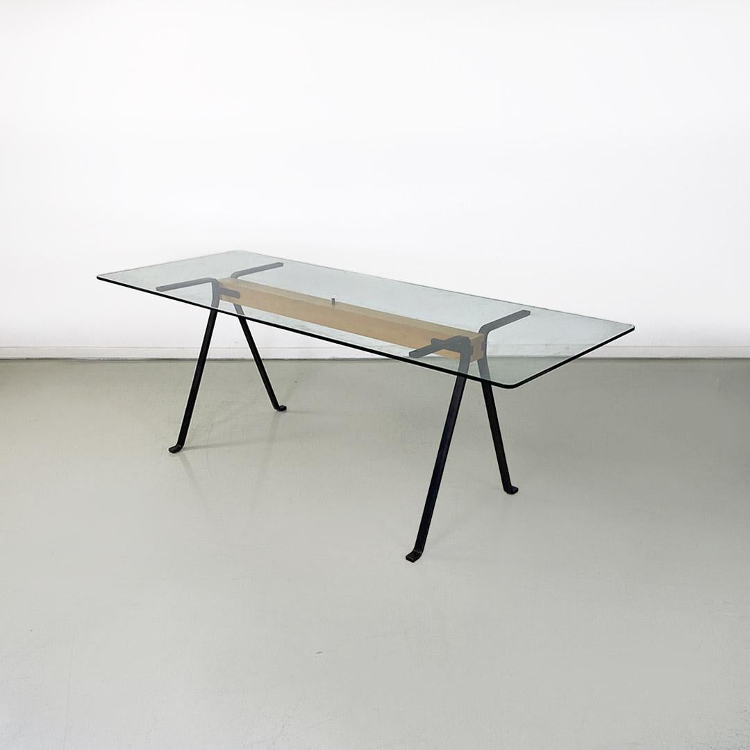 Modern dining table or desk, cast iron, tempered glass and wood, Frate model by Enzo Mari for Driade Italia, c. 1980.
Frate model dining table or desk with rectangular tempered glass top with rounded corners, frame composed of a square-section solid