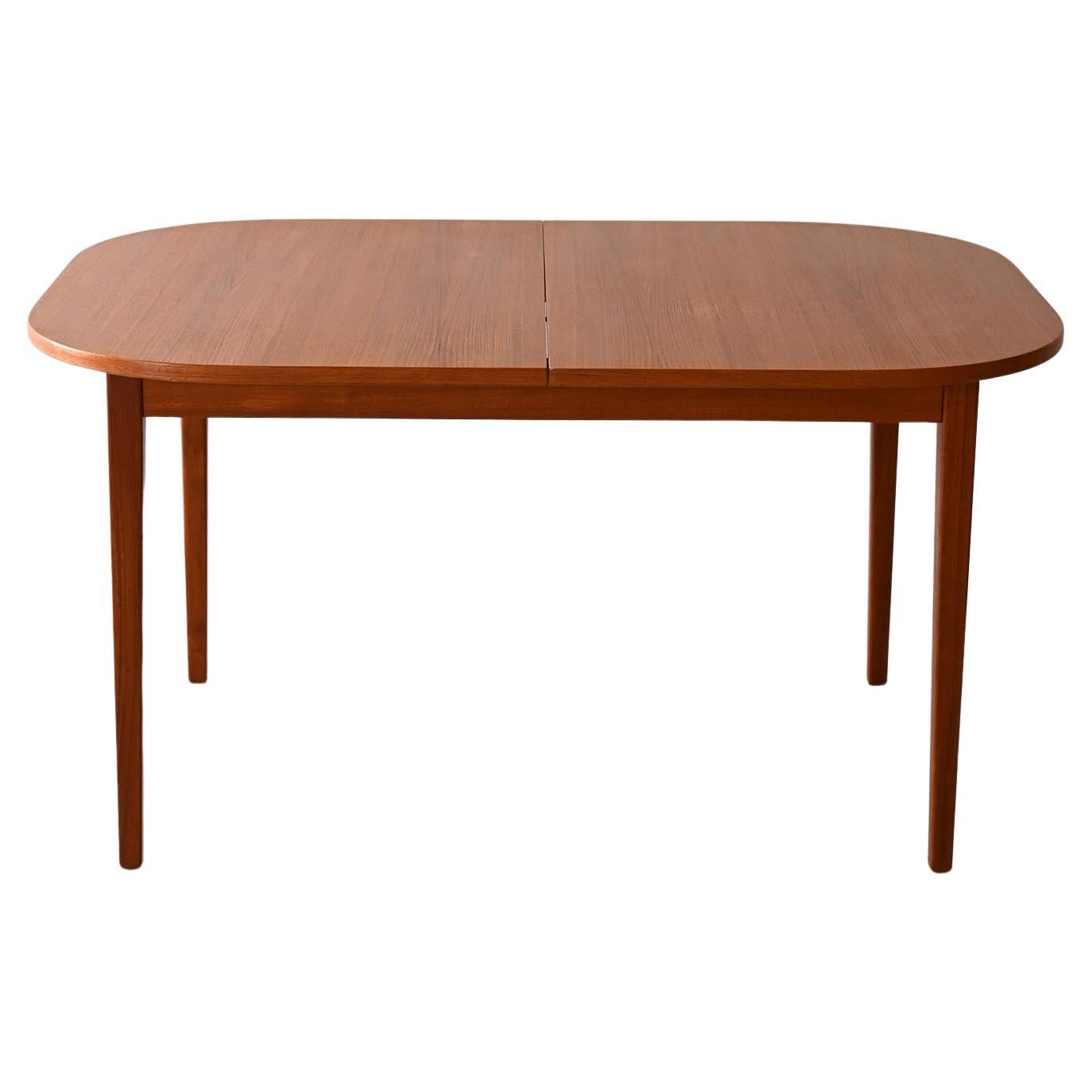 Oval extending teak table For Sale