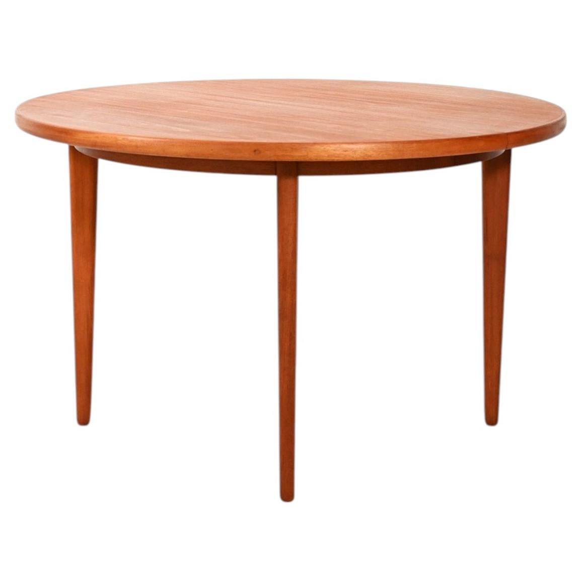 Swedish round extendable teak table from the 1960s For Sale