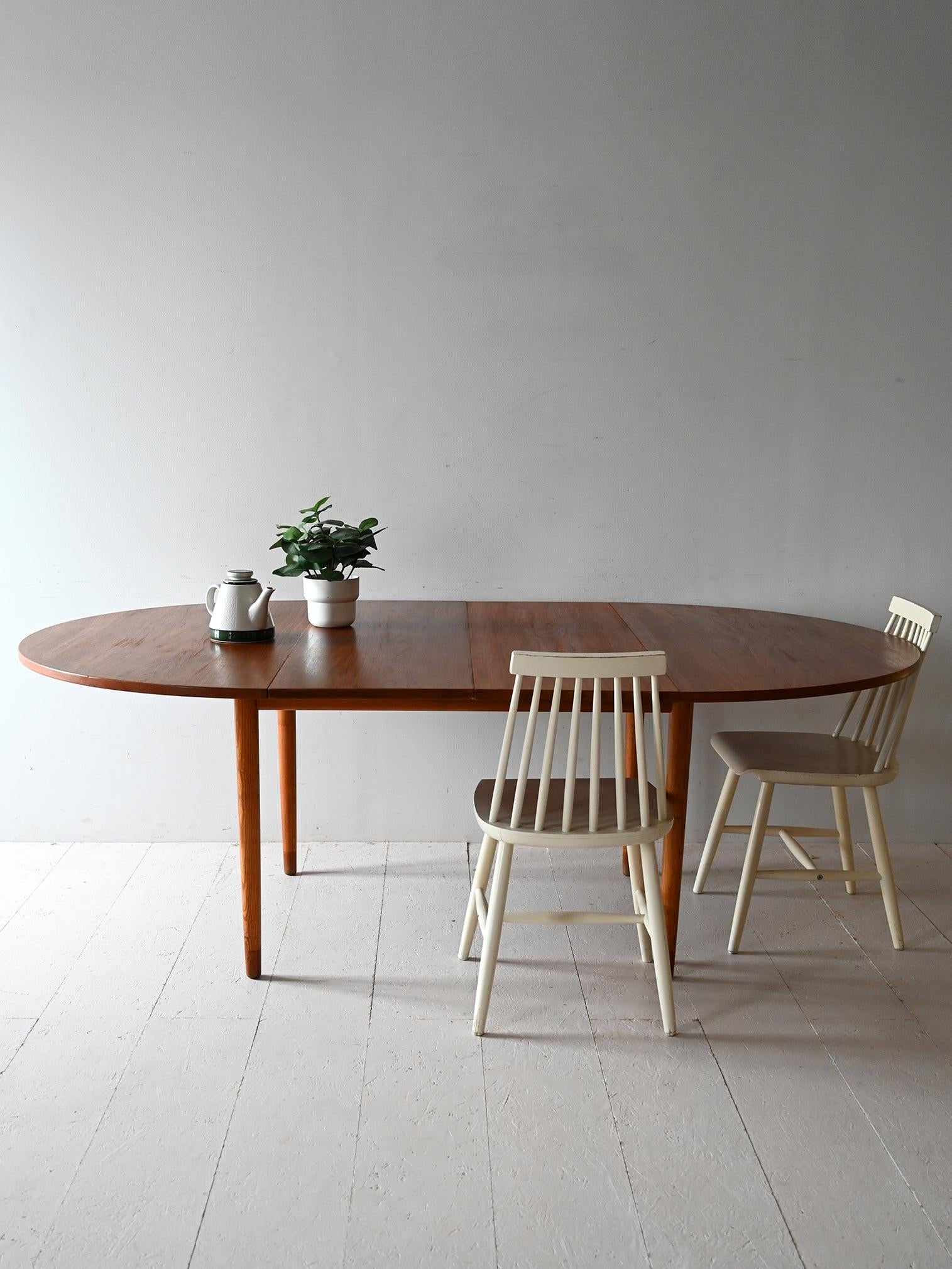 Teak dining table designed by Nils Jonsson for Hugo Troeds, 1960s, with two built-in central extension leaves.

Designed by Nils Jonsson for renowned Swedish manufacturer Hugo Troeds, Malta is a 1960s teak dining table with a natural finish. The