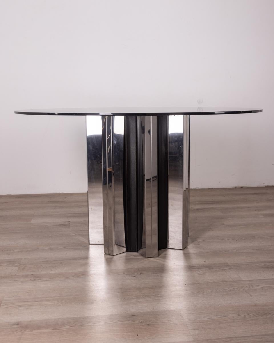 Table with chrome metal base and black leather, round blue crystal top, 1970s, Italian design.

CONDITION: In good condition, shows signs of wear given by time.

DIMENSIONS: Height 73 cm; Diameter 130 cm

MATERIAL: Metal, Leather and Glass

YEAR OF