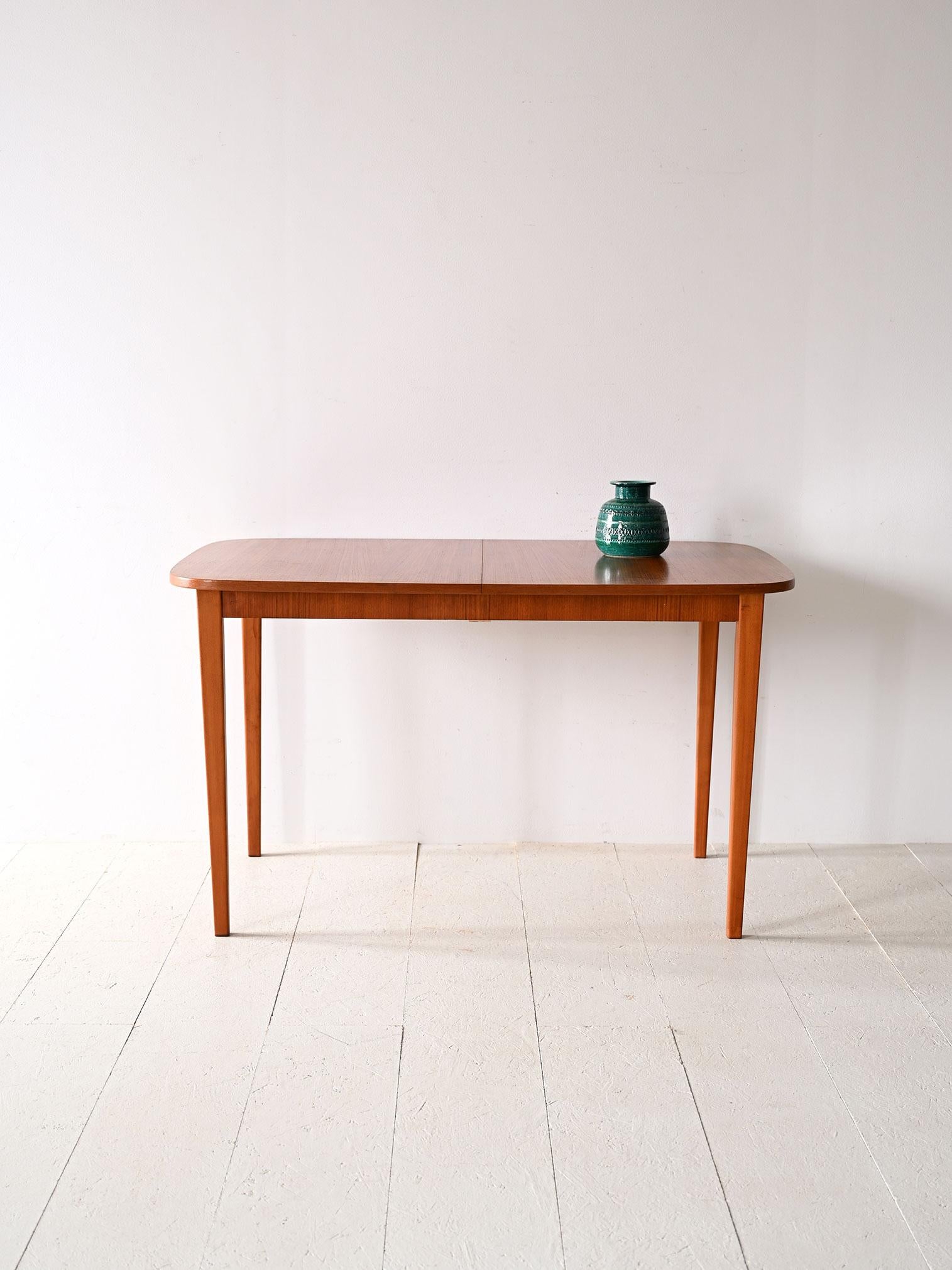 Vintage dining table with rounded corners.

This vintage furniture piece of Nordic origin traces the taste and functionality typical of Scandinavian design. The supporting structure is made of light birch wood while the top is made of formica to