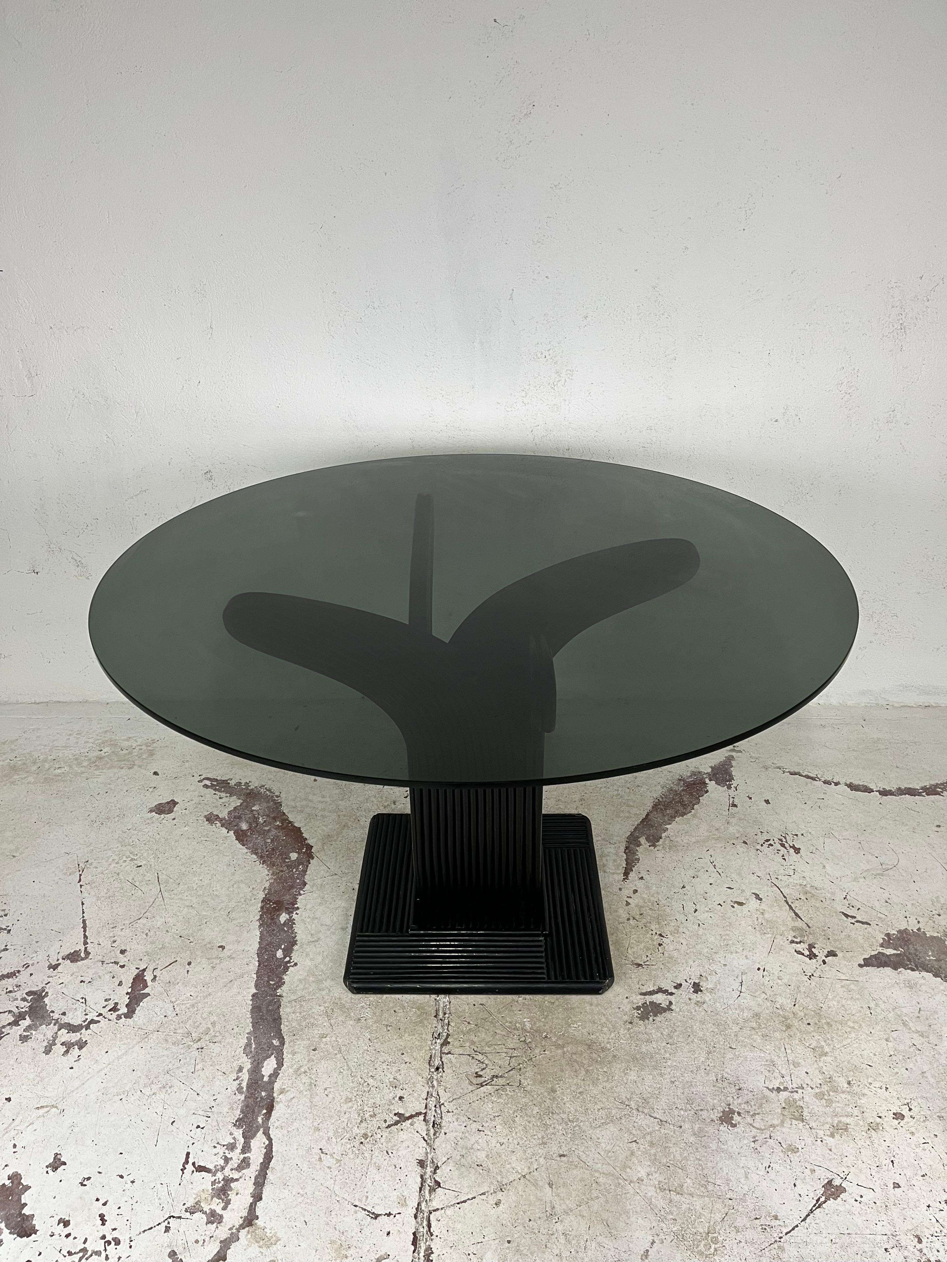 Beautiful table with finely crafted and curved bamboo and rattan frame with smoked glass top, designed by Maurizio Mariani and Giusto Purini for Vivai del Sud in the 1970s.

The table has been thoroughly cleaned, is in excellent condition, the glass