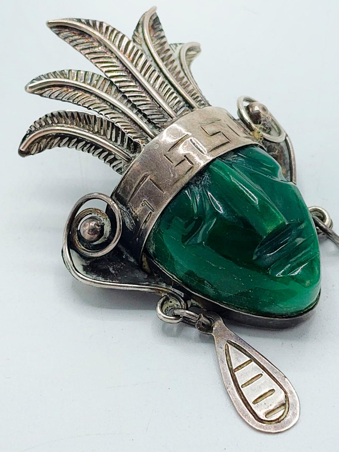 Folk Art Taxco Mexican Sterling Mask Brooch with Large Green Agate and Stamped Details For Sale
