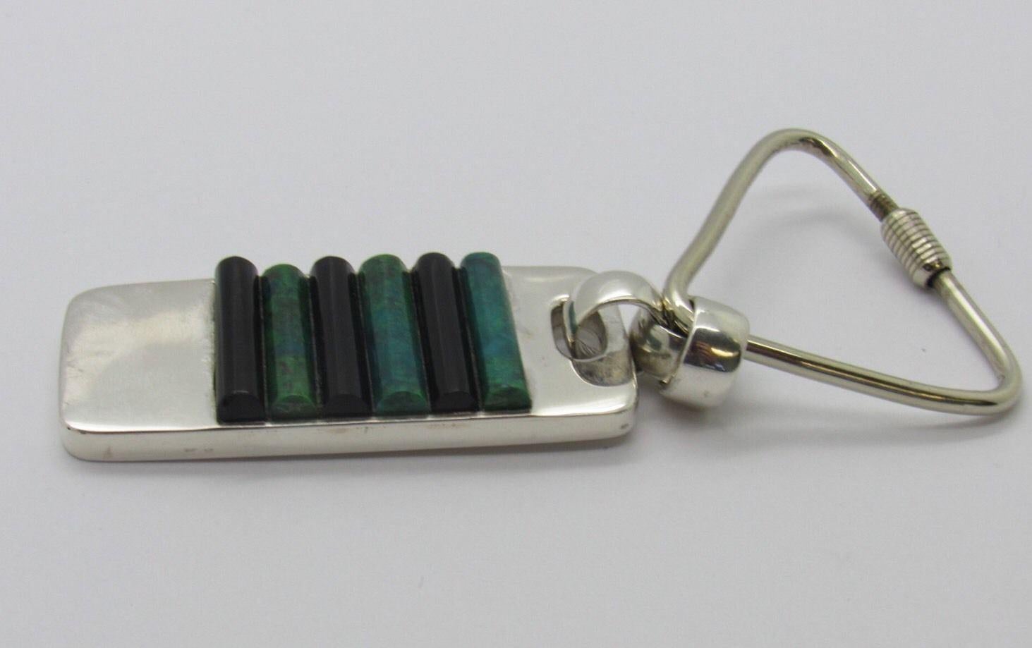 Taxco Mexico J. Gomes sterling silver tag key chain with an inlay of 3 onyx and 3 green turquoise stones. Marked: STERLING, 925, J. GOMES, TC-38, MEXICO. Measures: 3 1/2
