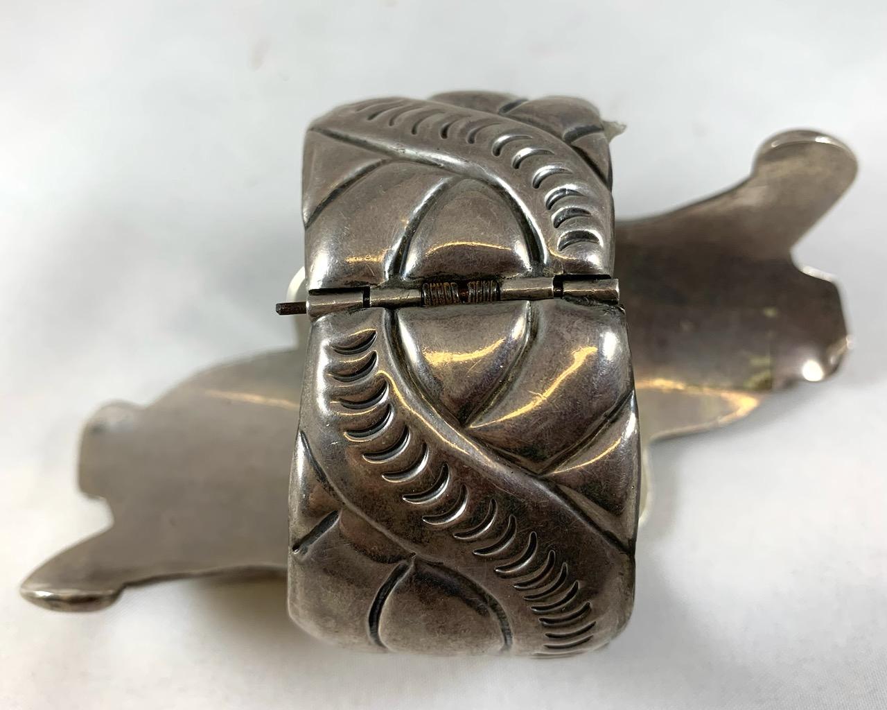 This unique Taxco clamper bracelet depicts the Mayan god Yumil Kaxob, the god of maize (corn) and agriculture. Made in Mexico of 925 silver, it has a hollow interior making it lightweight to wear. The clamper design makes this bracelet easy to take