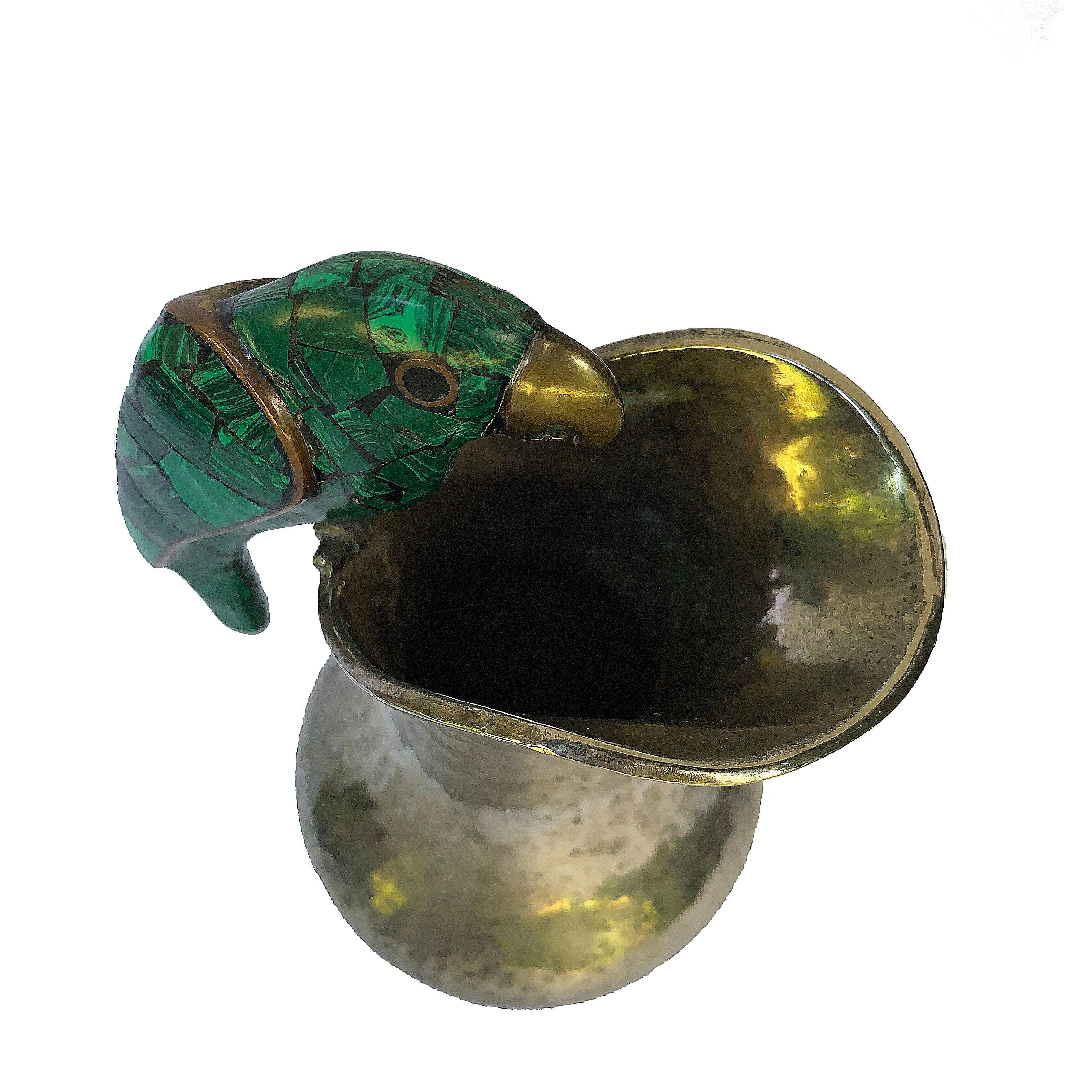 This petite vase by Fajardo Taxco Mexico silver plated vase and malachite brass parrot, is eye catching. The parrot is perched on the rim and its placement balances the shape of the rim perfectly. The parrot is adorned with a malachite mosaic, with