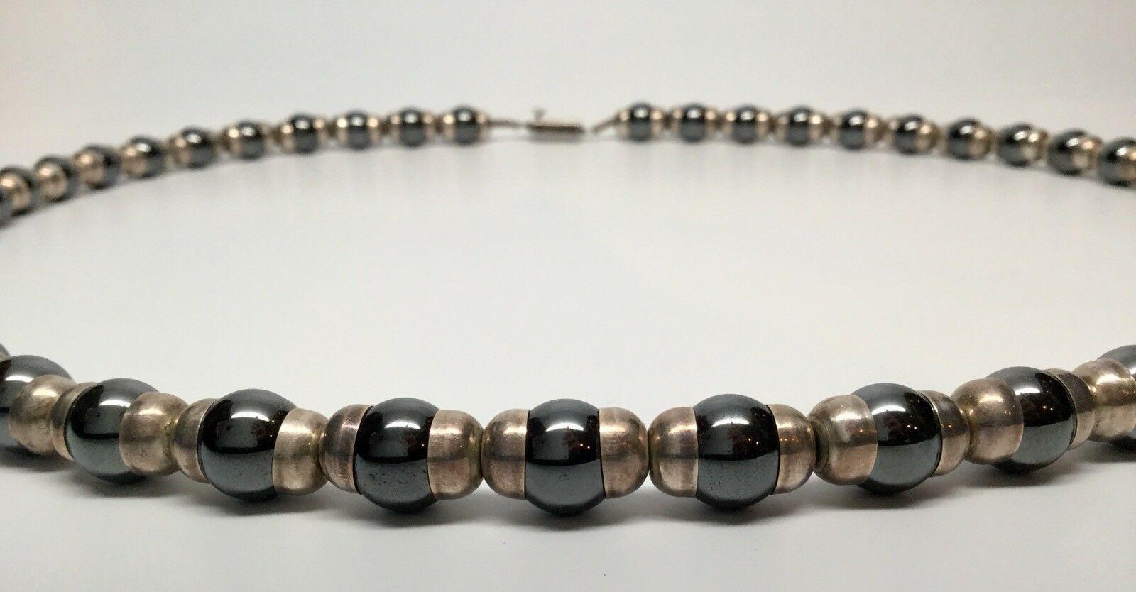 Taxco Mexico Sterling Silver And Hematite Bead Necklace

Marked: TH-64 MEXICO, 925

Measurements:

29 1/4