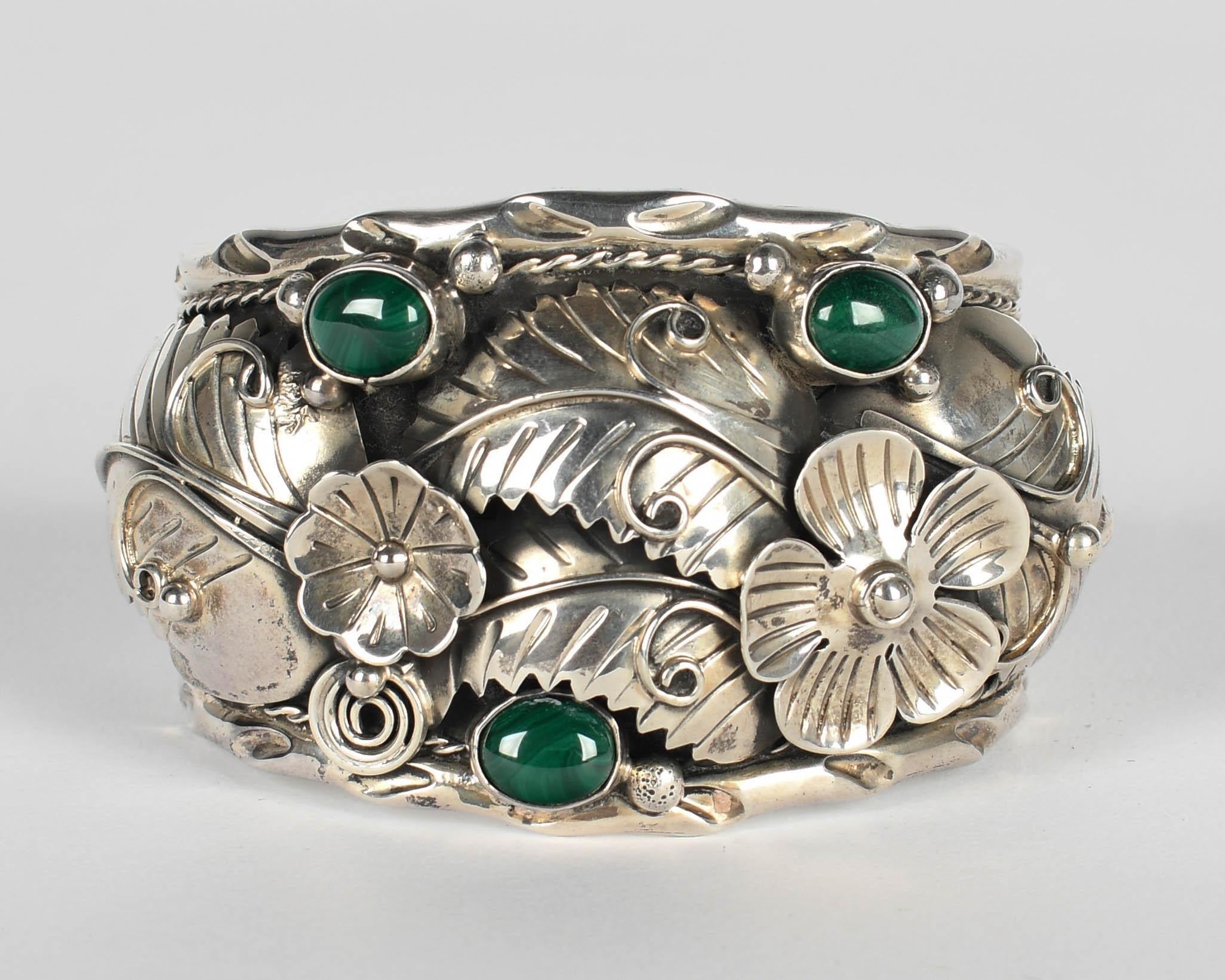 A Mid Century Taxco Mexico slide cuff bracelet, hand-crafted with bold flower design featuring three oval shaped green malachite stones set in 950 sterling silver. Stamped 950 Taxco Mexico. Circa 1950s
3.25