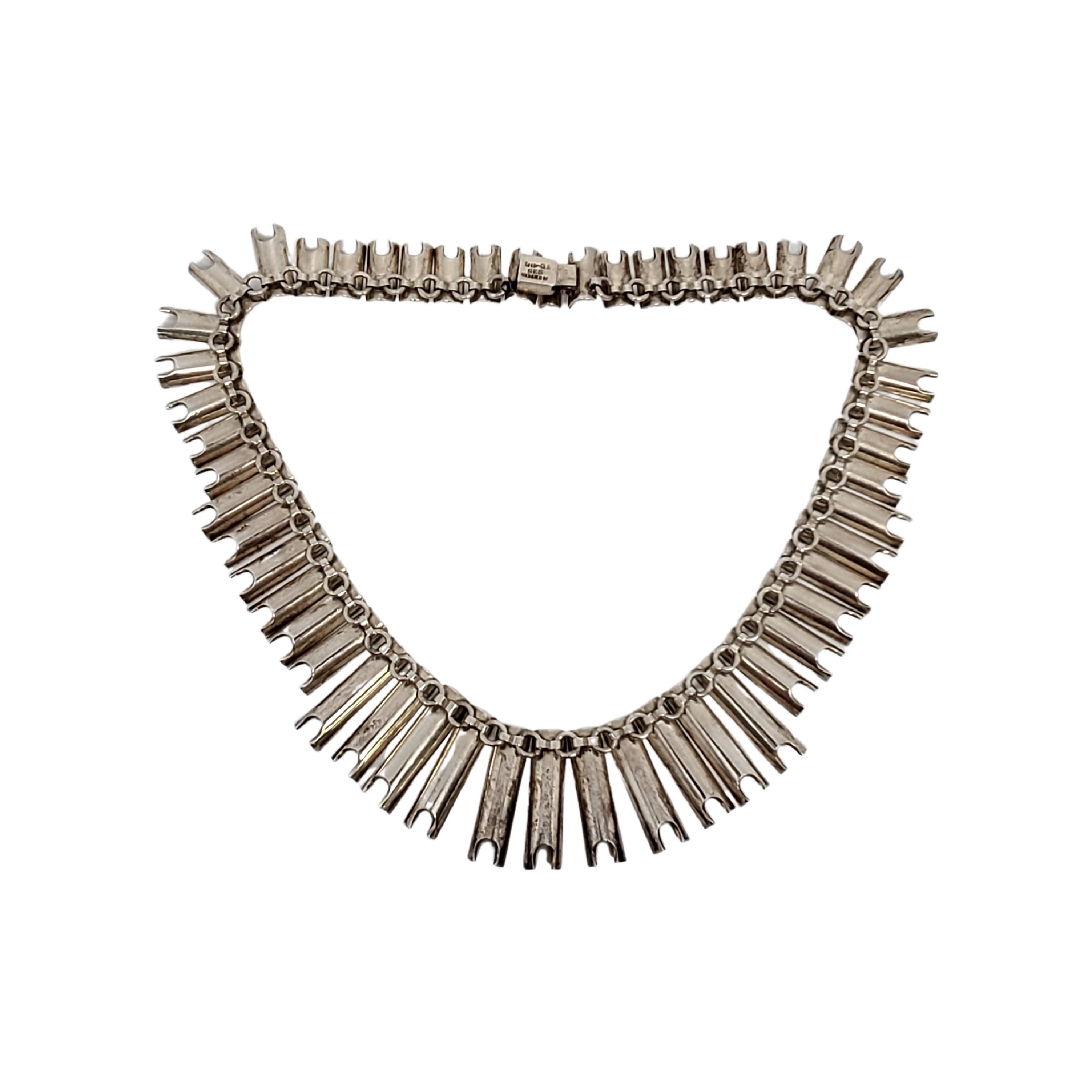 Sterling silver concave graduated link necklace by Taxco Mexico artisan TB-84.

Heavy and substantial necklace features concave links in graduated sizing with the longest links at the center, tapering to shorter links as the move to the ends. Slide