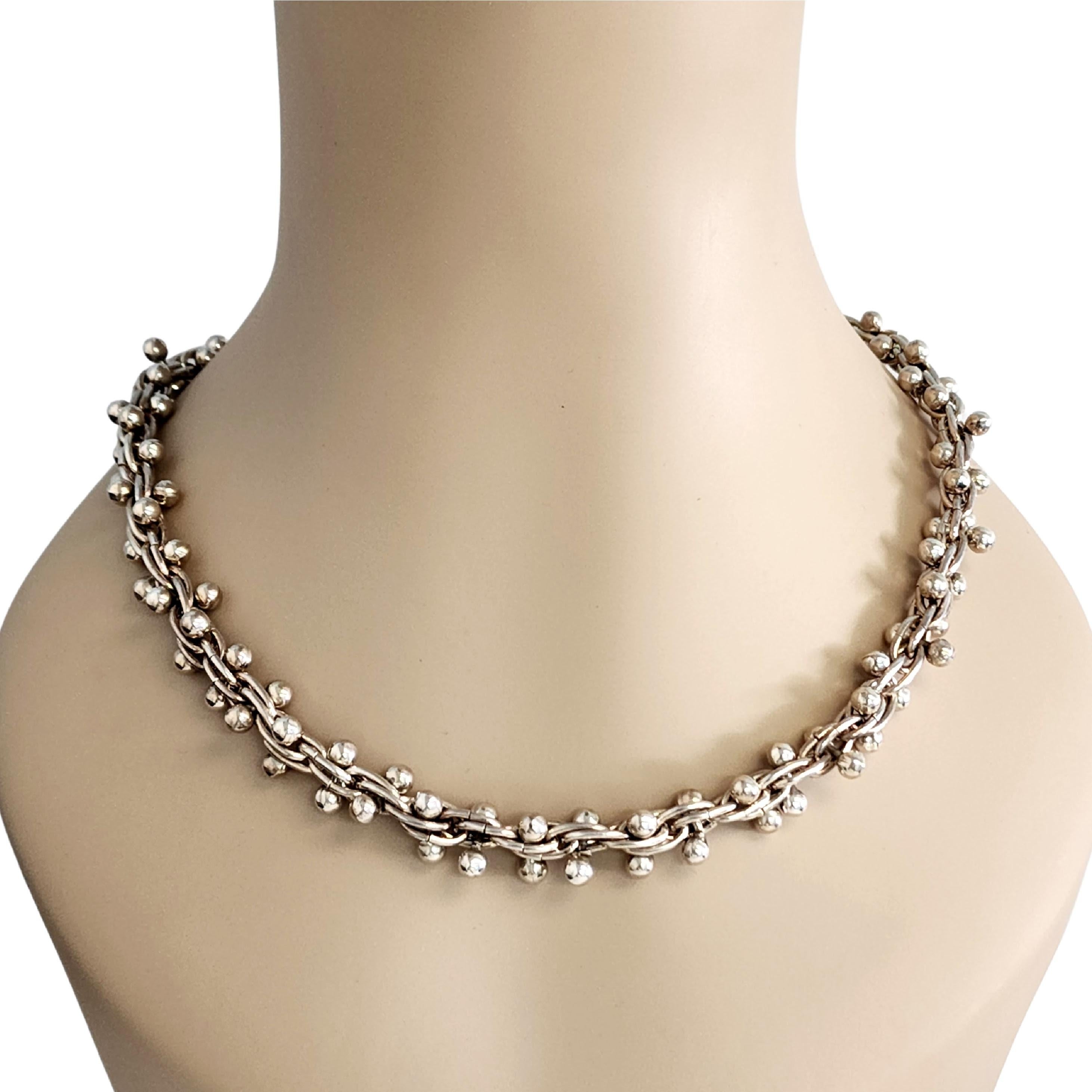 Sterling silver DNA weave and bead necklace by Taxco Mexico artisan, TJ-39.

Heavy and substantial necklace featuring a DNA weave design adorned with silver bead balls. Slide clasp closure.

Measures approx 20