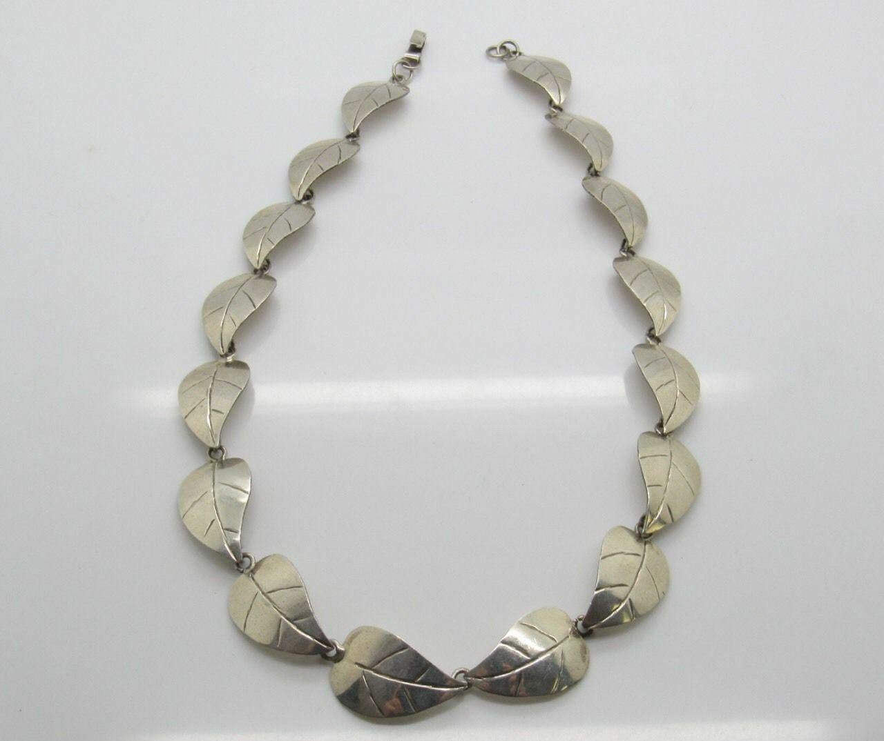 Taxco Mexico TJ-49 sterling silver leaf necklace.

Marked: 925, MEXICO, TJ-29 (silversmith)

Measures: 19 1/4