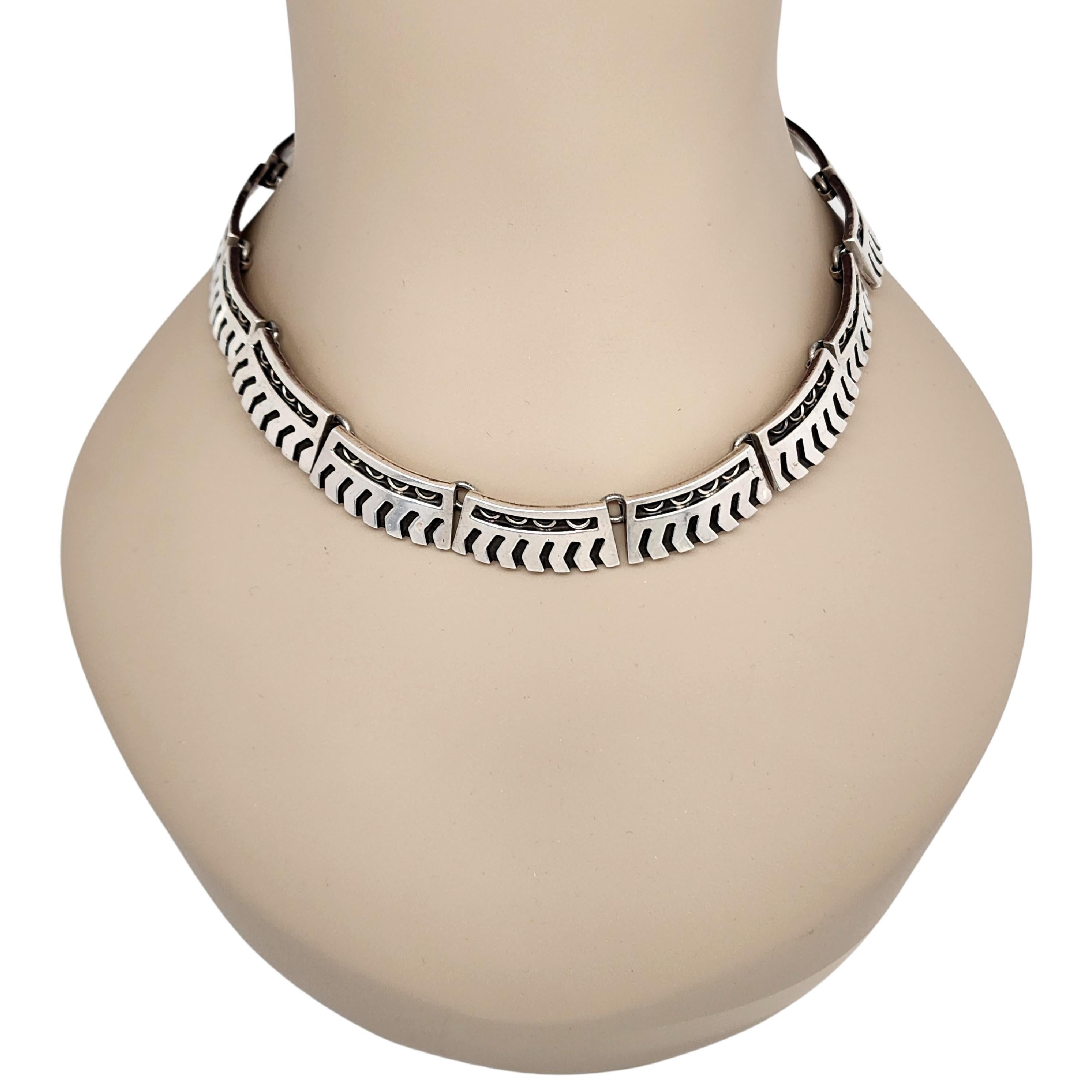 Sterling silver link necklace by Taxco Mexico artisan PAR TFO.

Heavy and substantial choker collar necklace features rectangular ornate links. Slide clasp closure.

Measures approx 16