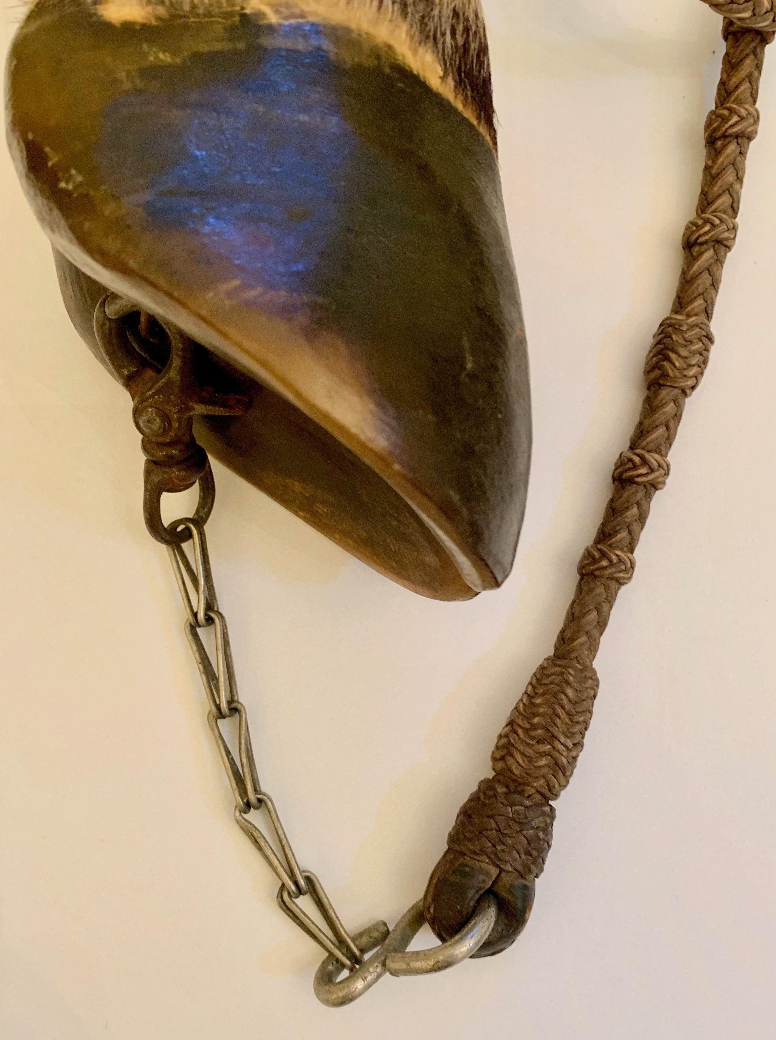 A bottle built into and around a taxidermy hoof - woven lanyard strap is beautifully made and attached my chain to the bottom of the hoof.

A handsome decorative piece and also useful as a practical canteen.